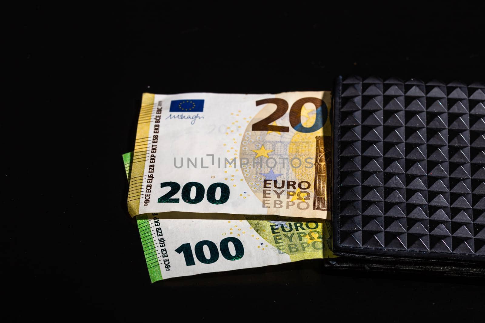 100 euro and 200 euro banknotes in black wallet isolated by vladispas