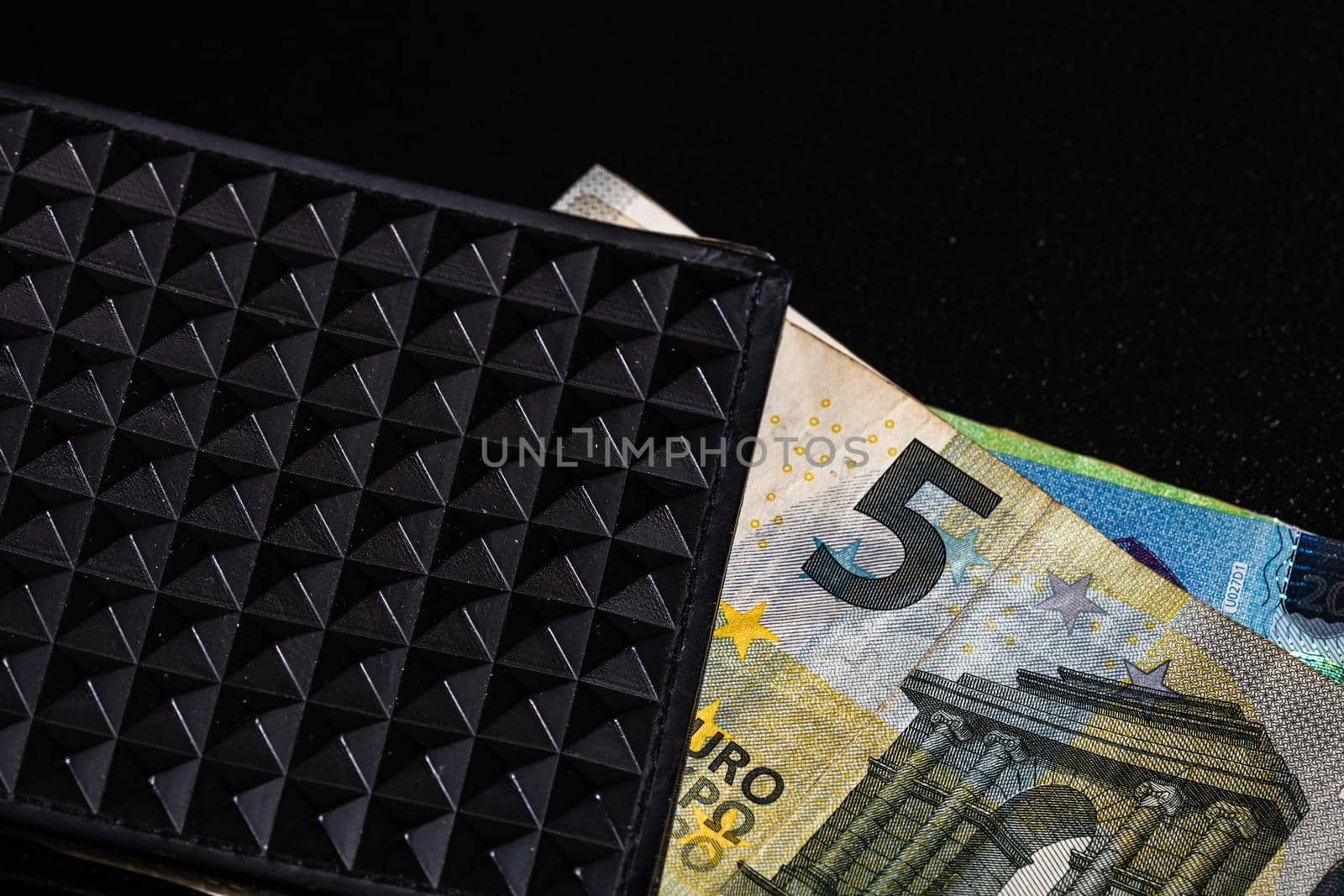 5 Euro money banknotes in black wallet isolated