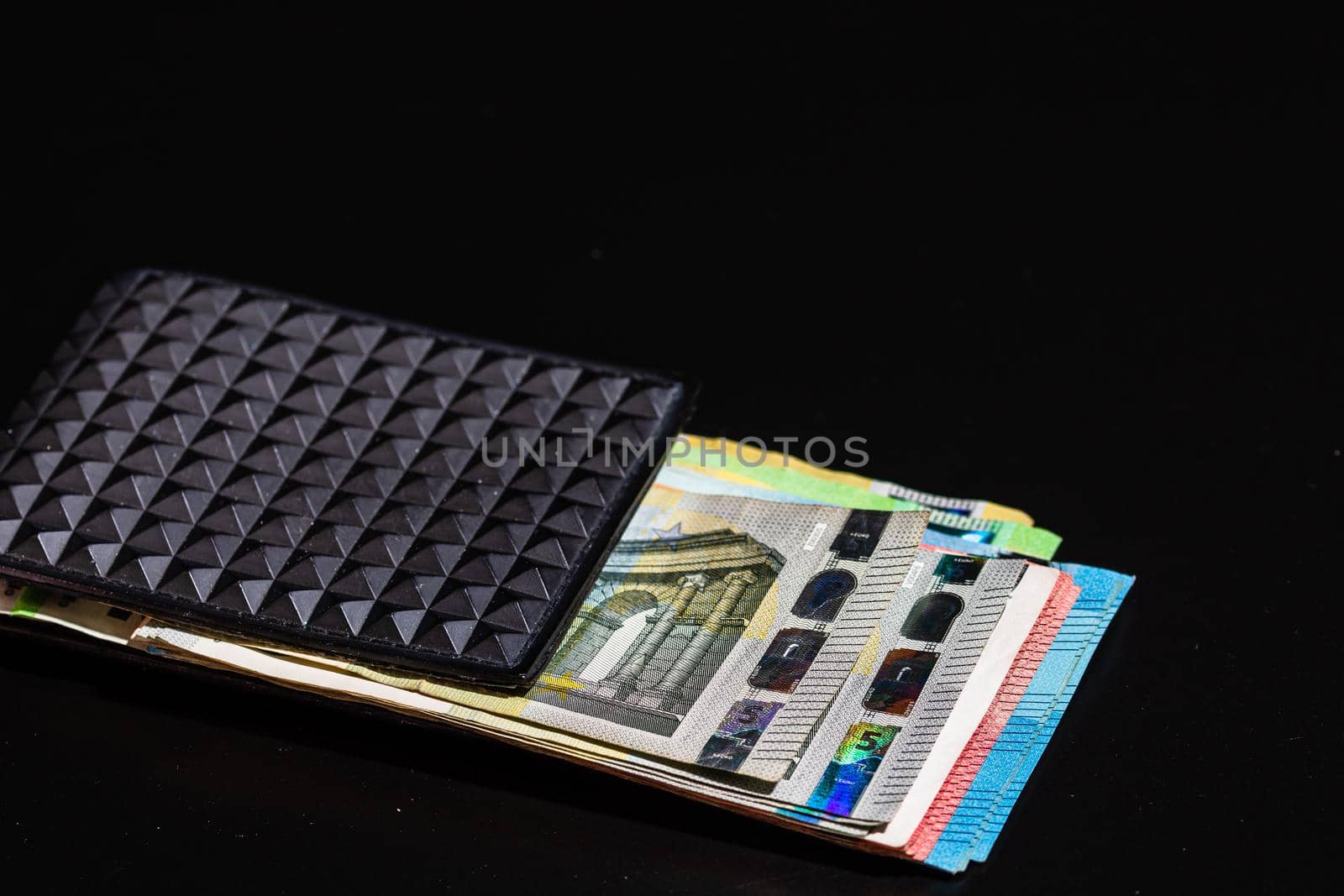 Euro banknotes in black wallet isolated. by vladispas