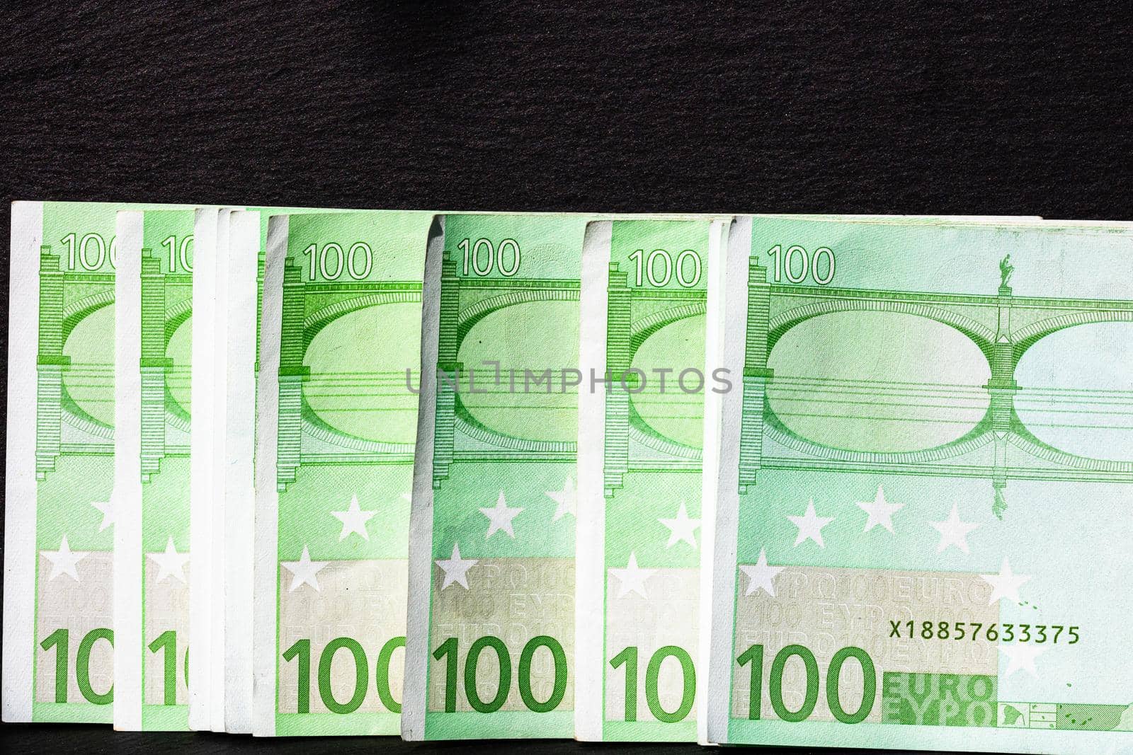 Selective focus on detail of euro banknotes. Close up macro detail of money banknotes, 100 euro isolated. World money concept, inflation and economy concept