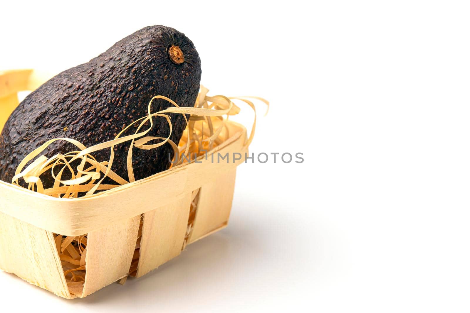 avocado in a basket on a white background close-up. isolate by roman112007