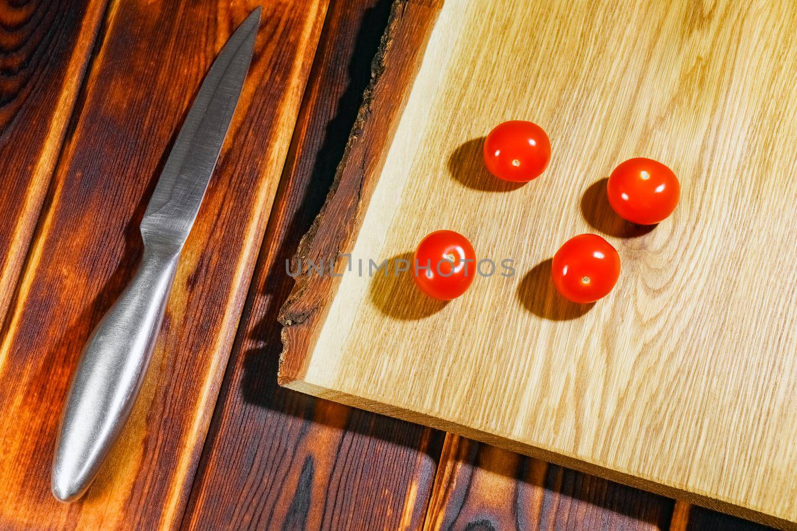tomato on a chopping Board as background by roman112007