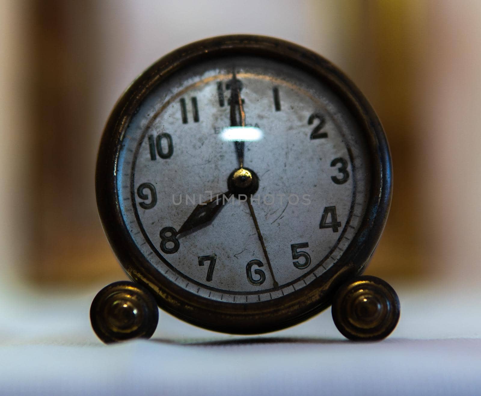 Close-up vintage clock with white base and blurred background