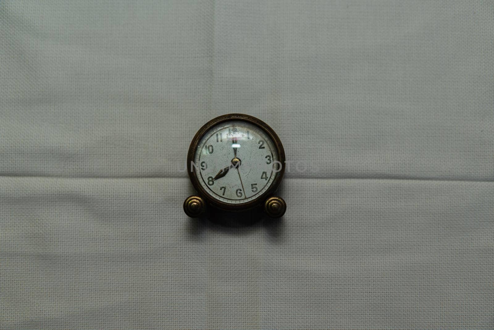 Centered vintage clock with white fabric backing