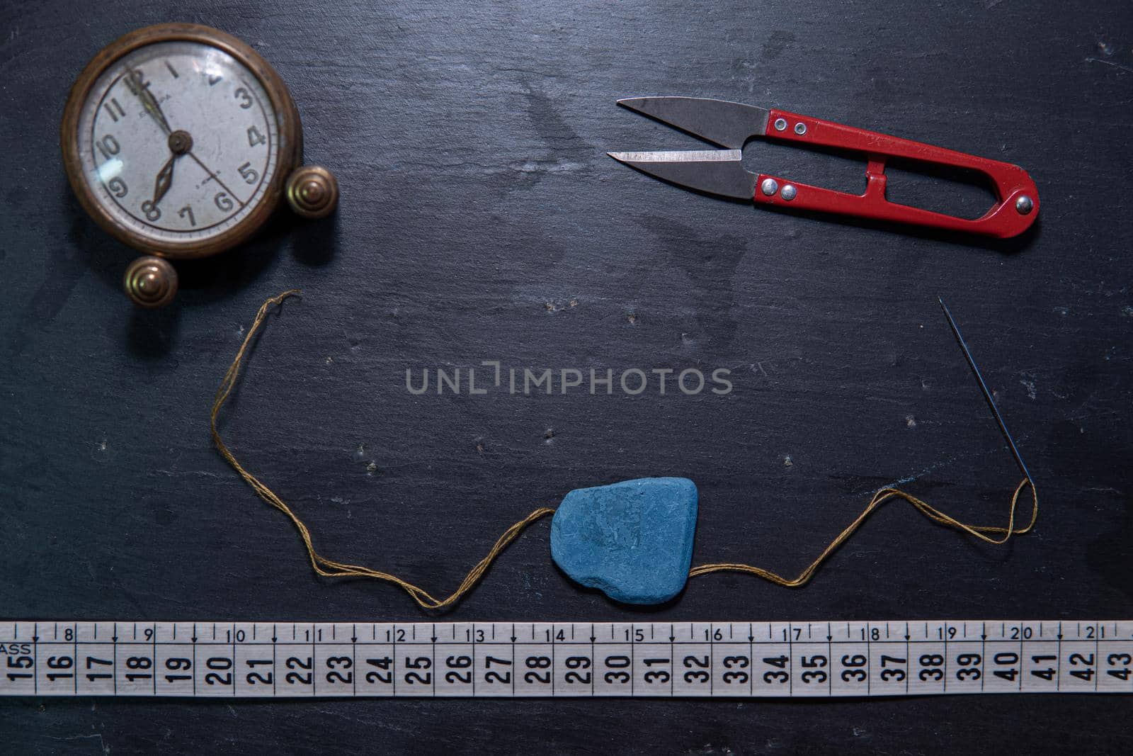 Black background with sewing utensils and a clock by xavier_photo