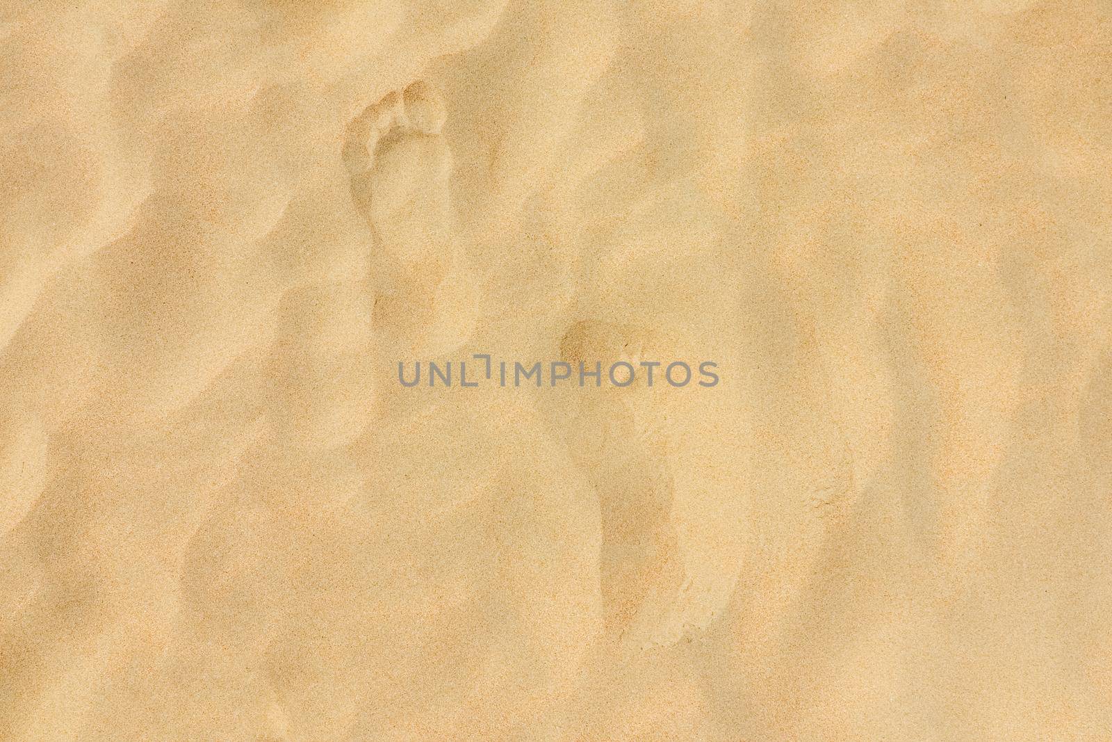 footprints on the beach dune sand as a background. High quality photo