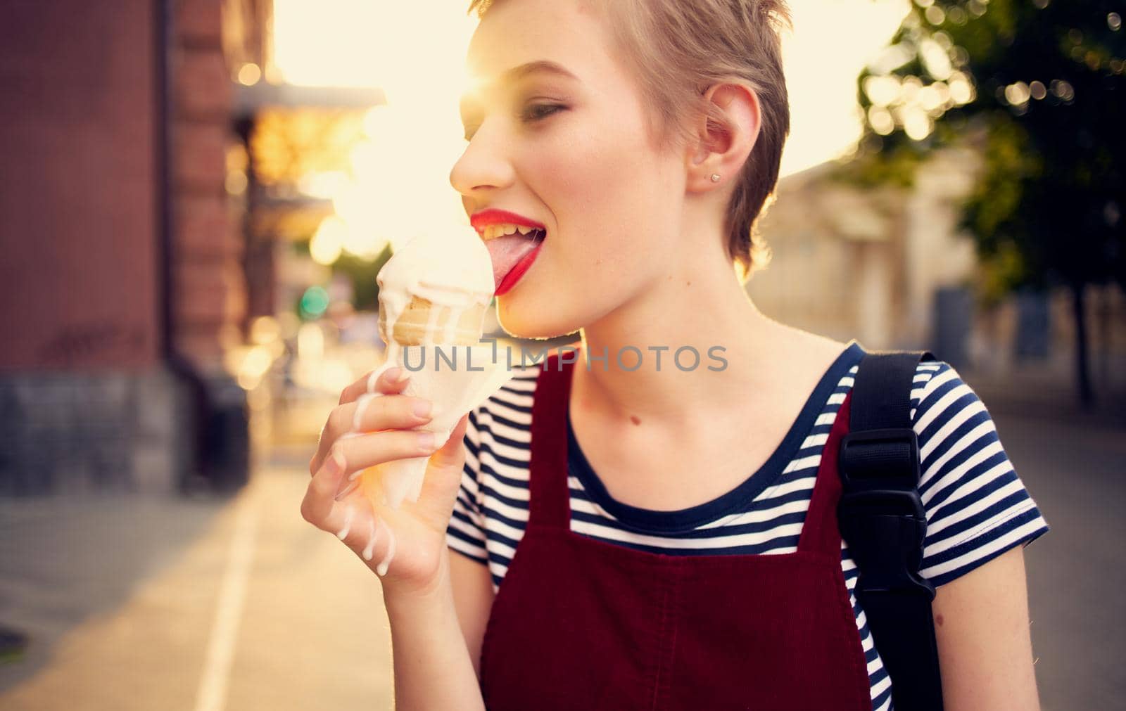 pretty woman with short hair eating ice cream outdoors leisure walk. High quality photo