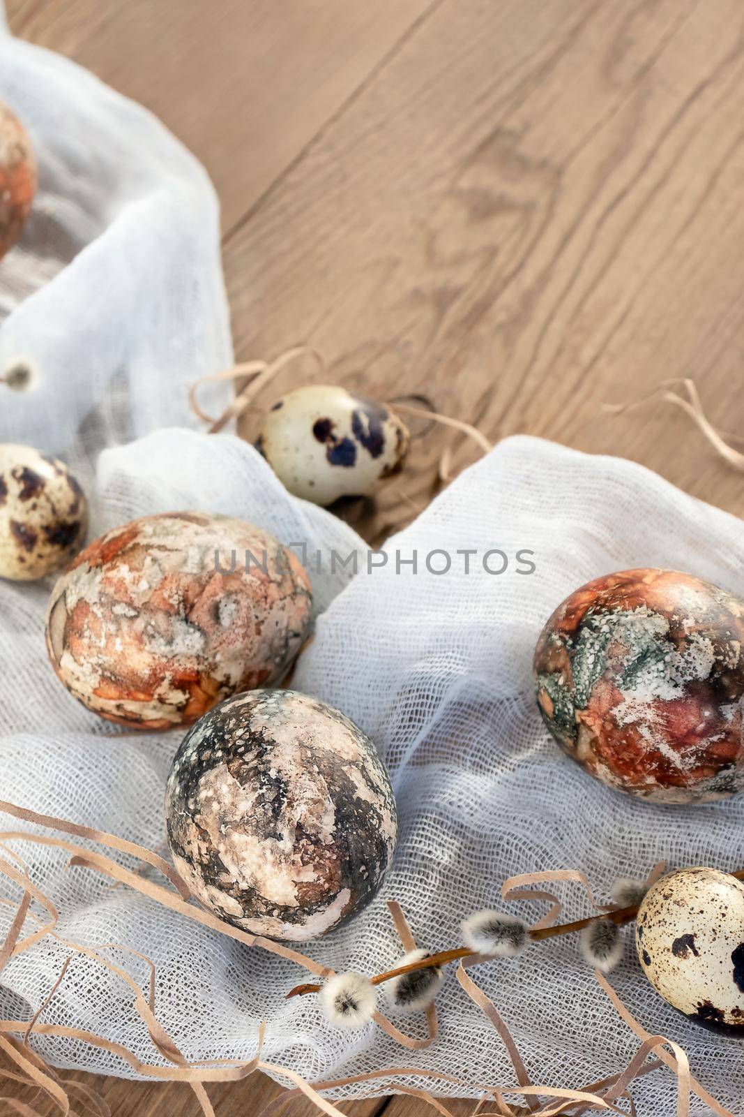 Easter composition - Easter eggs painted with natural dyes on a wooden table, copyspace.