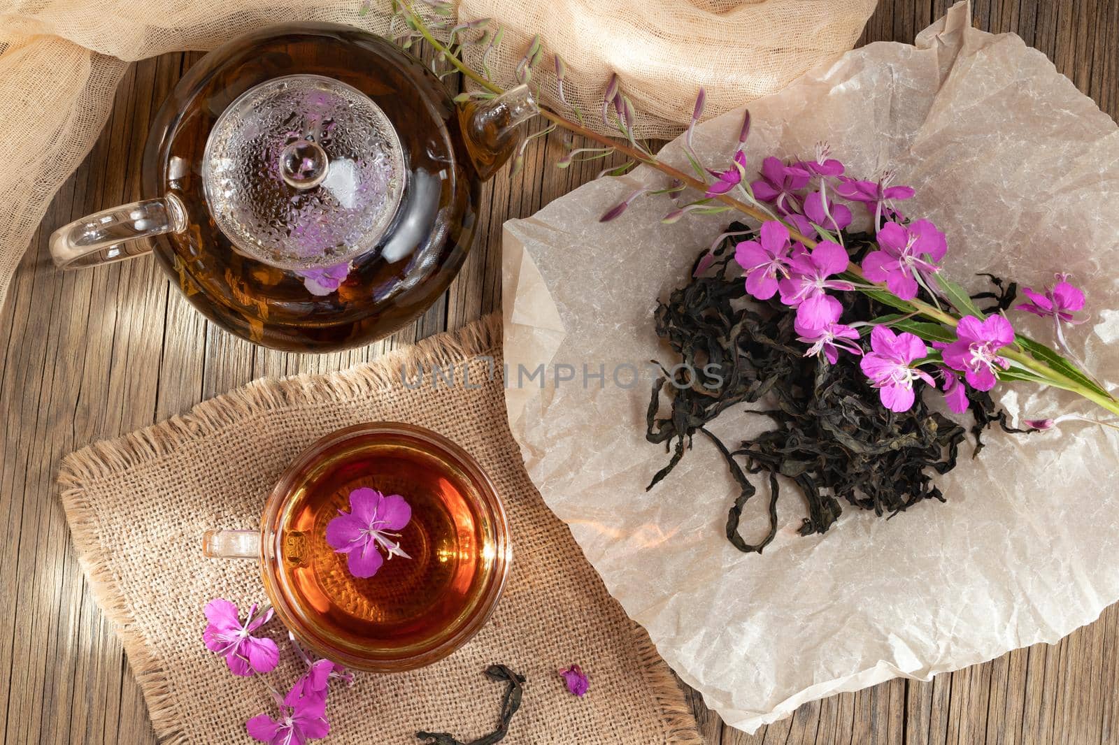 Herbal tea made from fireweed known as blooming sally in teapot and cup, top view.