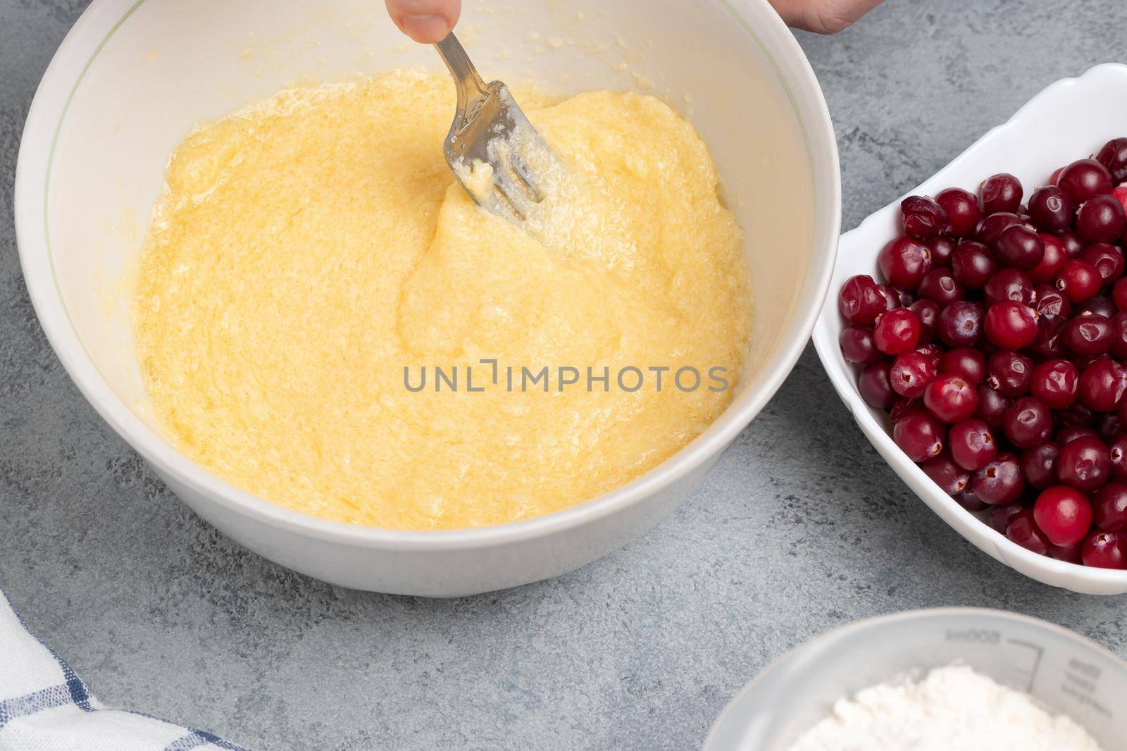 Making a dough for a sweet cranberry pie. Mixing butter and sugar by galsand