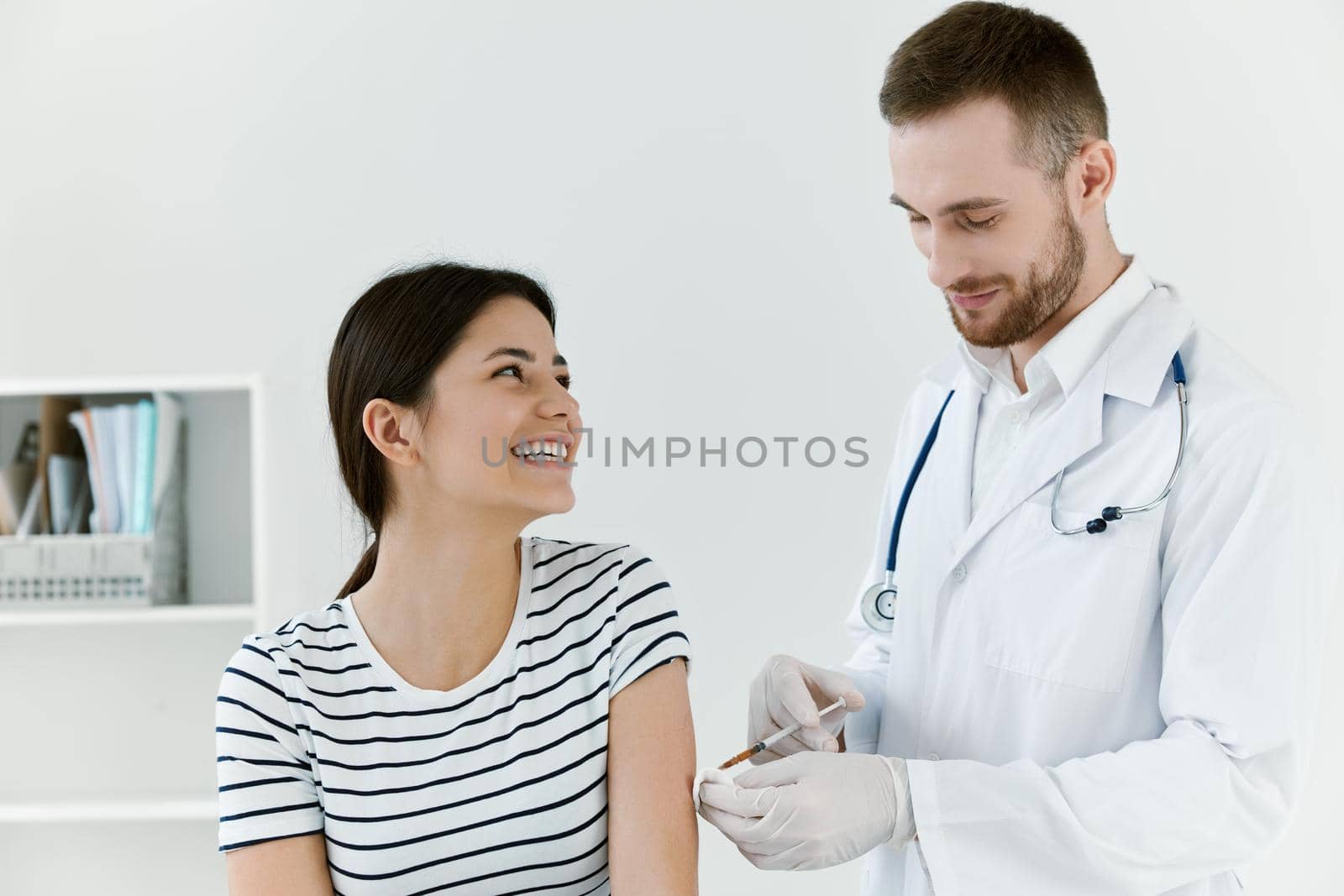 male doctor in a white coat a syringe in the hands of an injection health. High quality photo