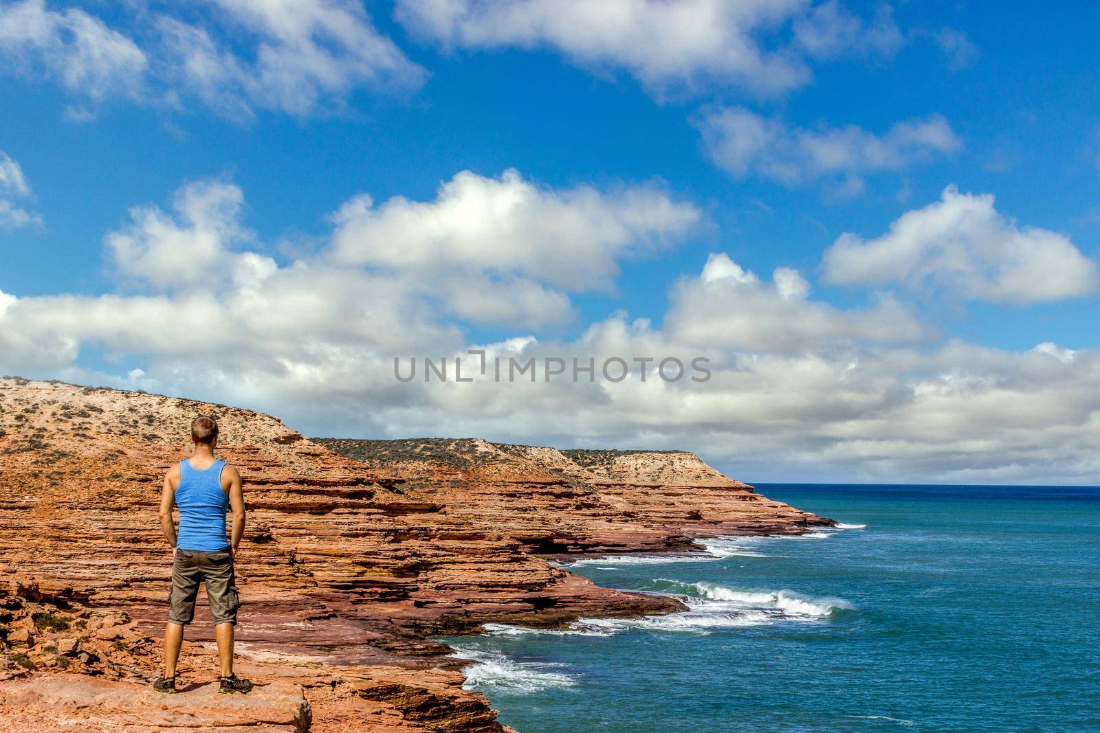 young man enyoing view of the Pot Alley in Kalbarri National Park, with beautiful clouds Western Australia by bettercallcurry