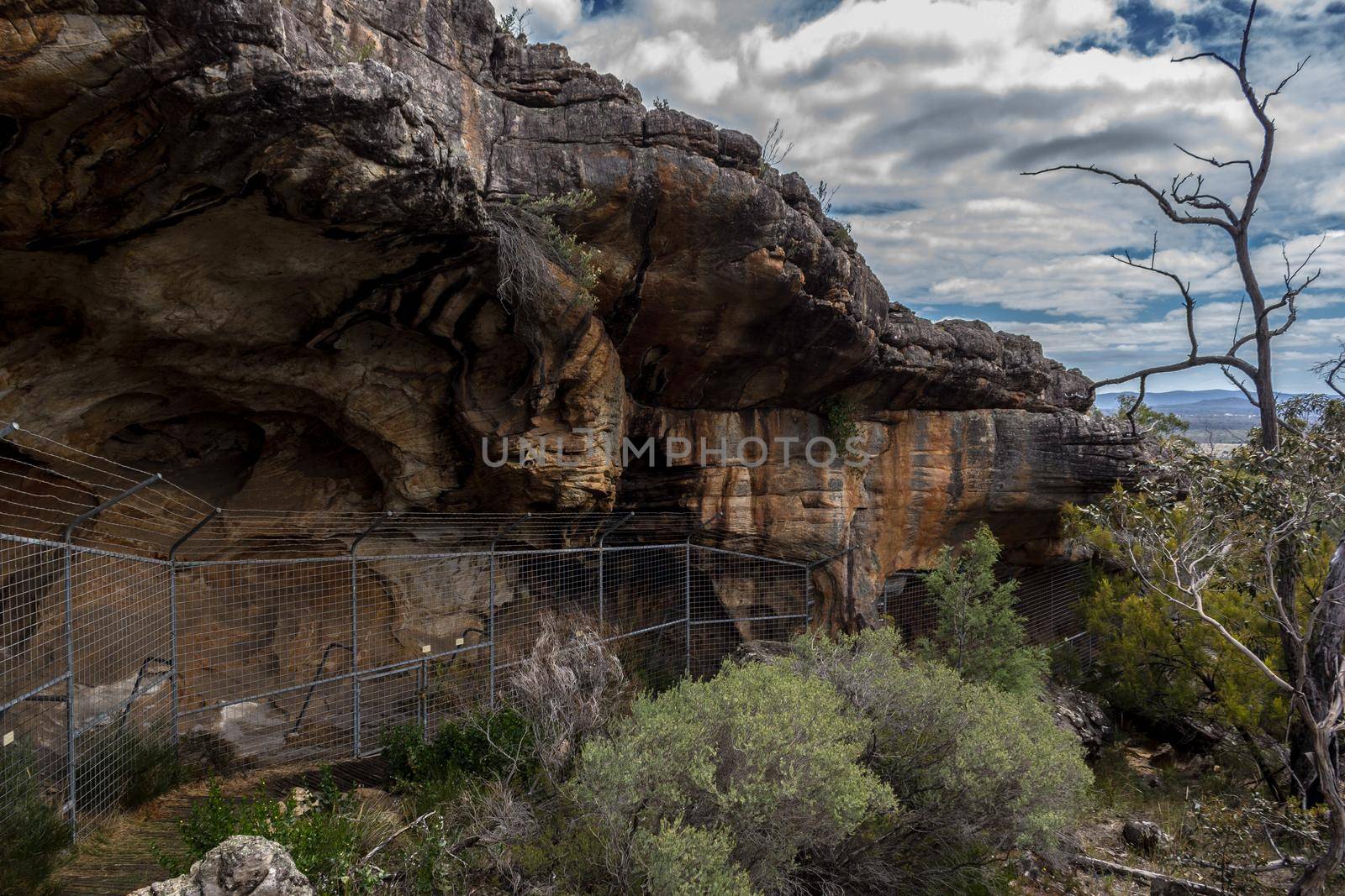 view over a Aboriginal cave, behind a fence, in australia by bettercallcurry
