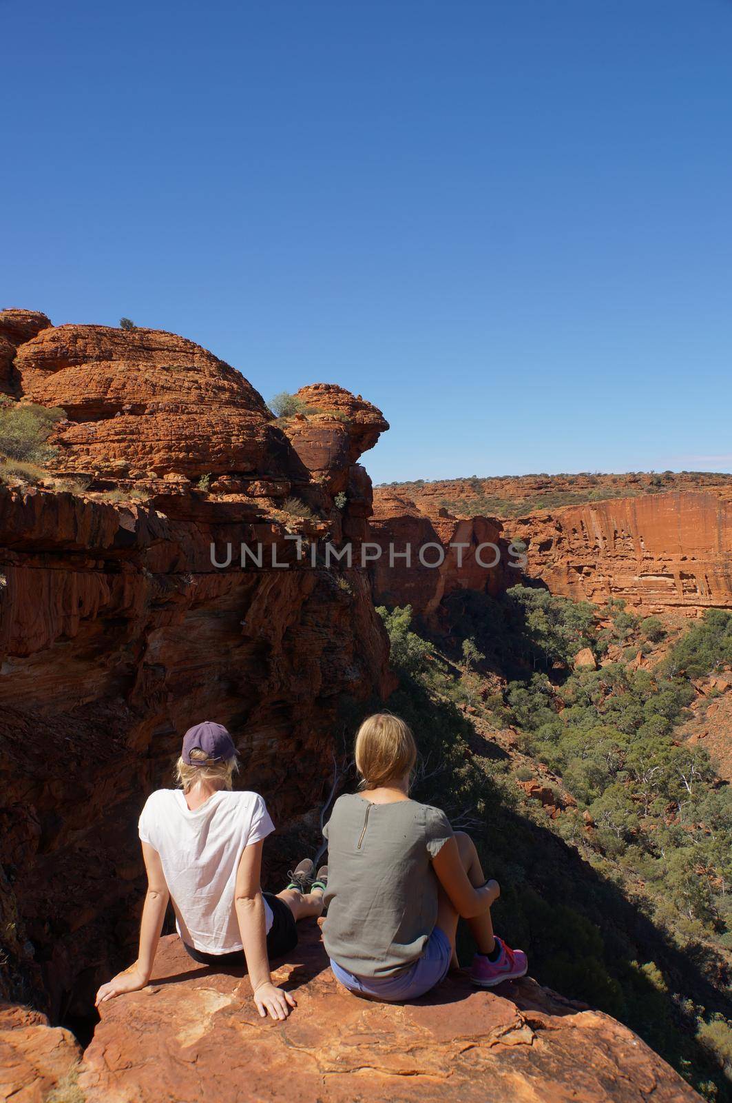 KINGS CANYON, AUSTRALIA May 5, 2015: young womens enyoing view of the Kings Canyon, Watarrka National Park, Northern Territory, Australia by bettercallcurry