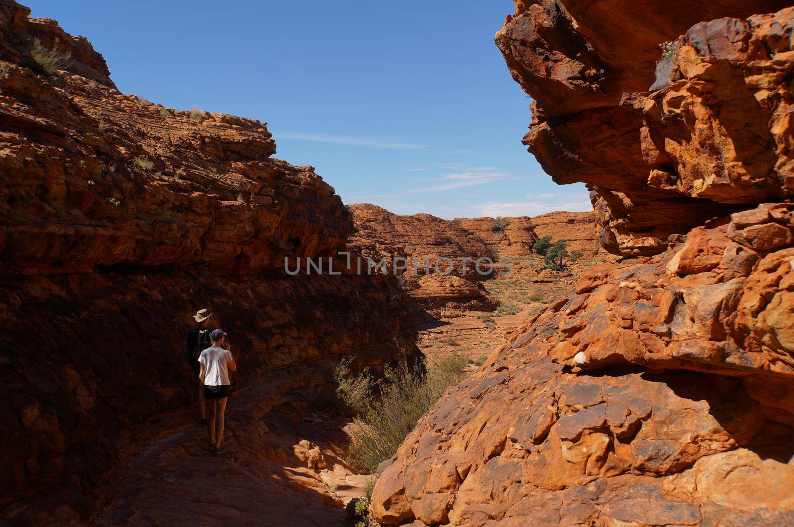 KINGS CANYON, AUSTRALIA May 5, 2015: young women and man hiking into the Kings Canyon, Watarrka National Park by bettercallcurry