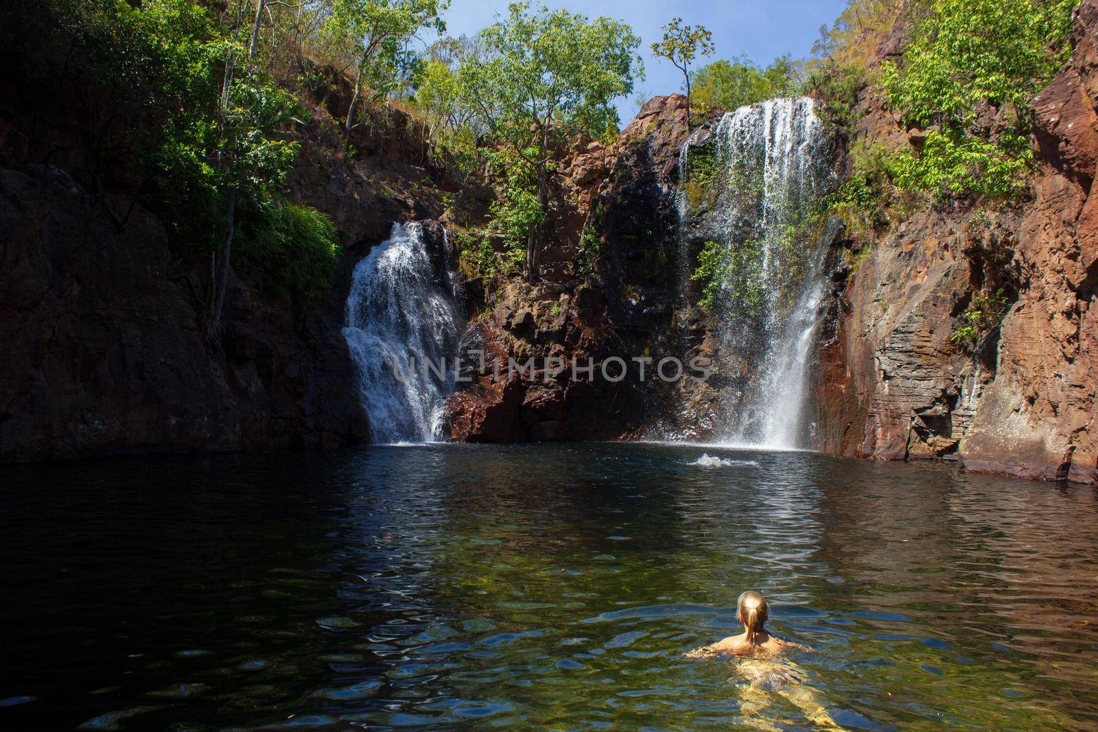 youn girl enjoy srefreshing swim at Florence Falls, very popular desitination for tourists and locals alike, Litchfield National Park, Northern Territory, Australia by bettercallcurry