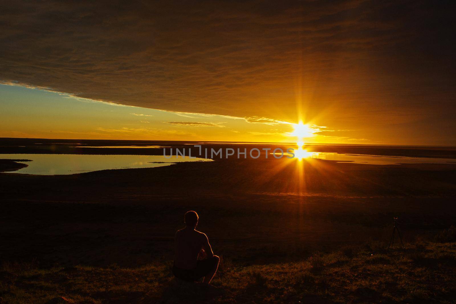 jung man enjoying beautiful sunset in the australian outback with 3 lakes, Gladstone scenic lookout