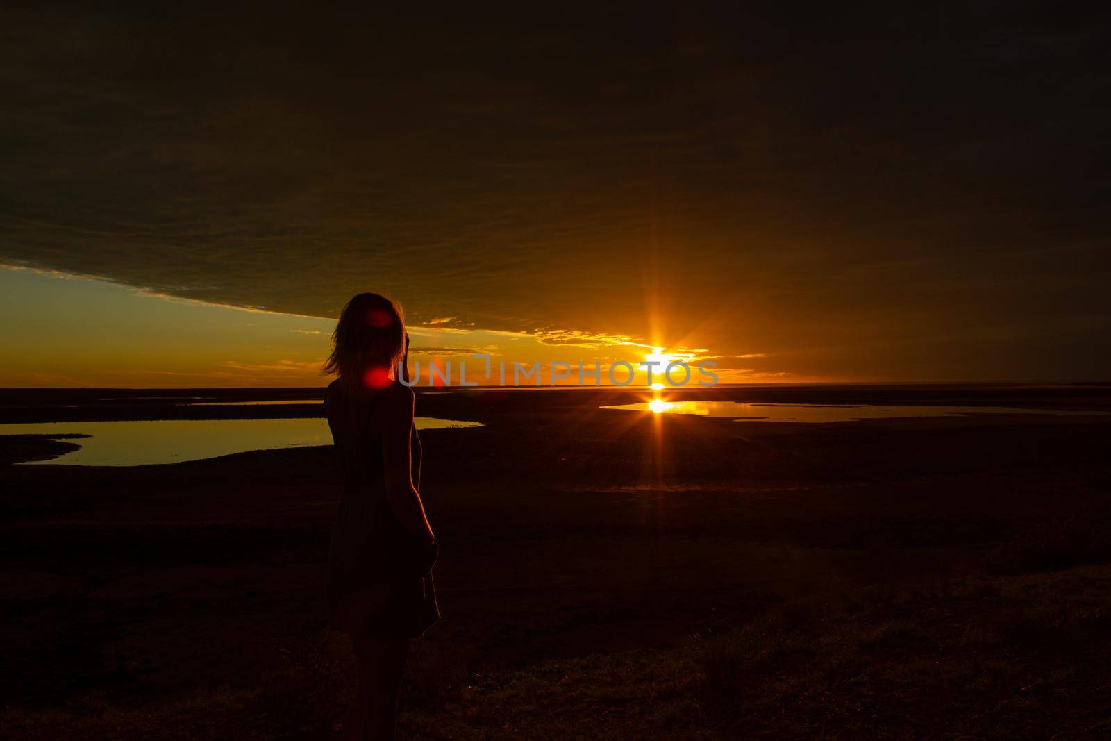 jung women enjoying beautiful sunset in the australian outback with 3 lakes, Gladstone scenic lookout