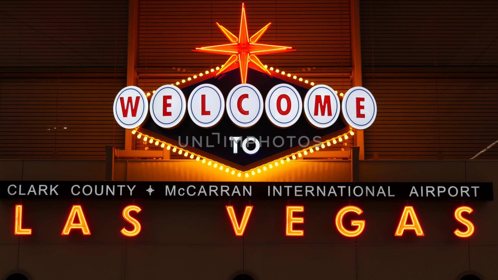 LAS VEGAS, NEVADA USA - 9 MAR 2020: Welcome to fabulous Sin City illuminated retro neon sign inside McCarran airport. Iconic greeting vintage styled signboard glowing. Gambling casino resort symbol.