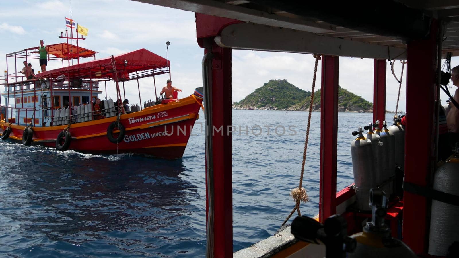 KOH TAO ISLAND, THAILAND - 29 JUNE 2019 Diving boat floating on surface of rippling sea in paradise exotic resort. Sports entertainment for tourists, diving deep under water with equipment