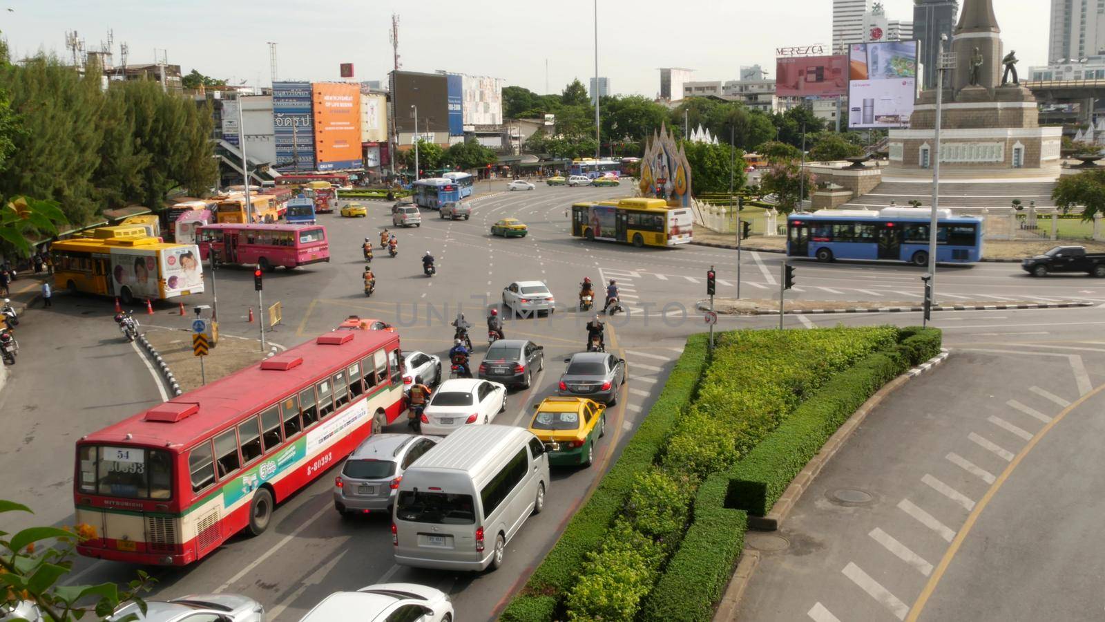 BANGKOK, THAILAND - 10 JULY, 2019: Rush hour traffic near Victory Monumet in Krungthep capital. Famous asian landmark and travel destination. Downtown modern city life. People and passengers of bts. by DogoraSun