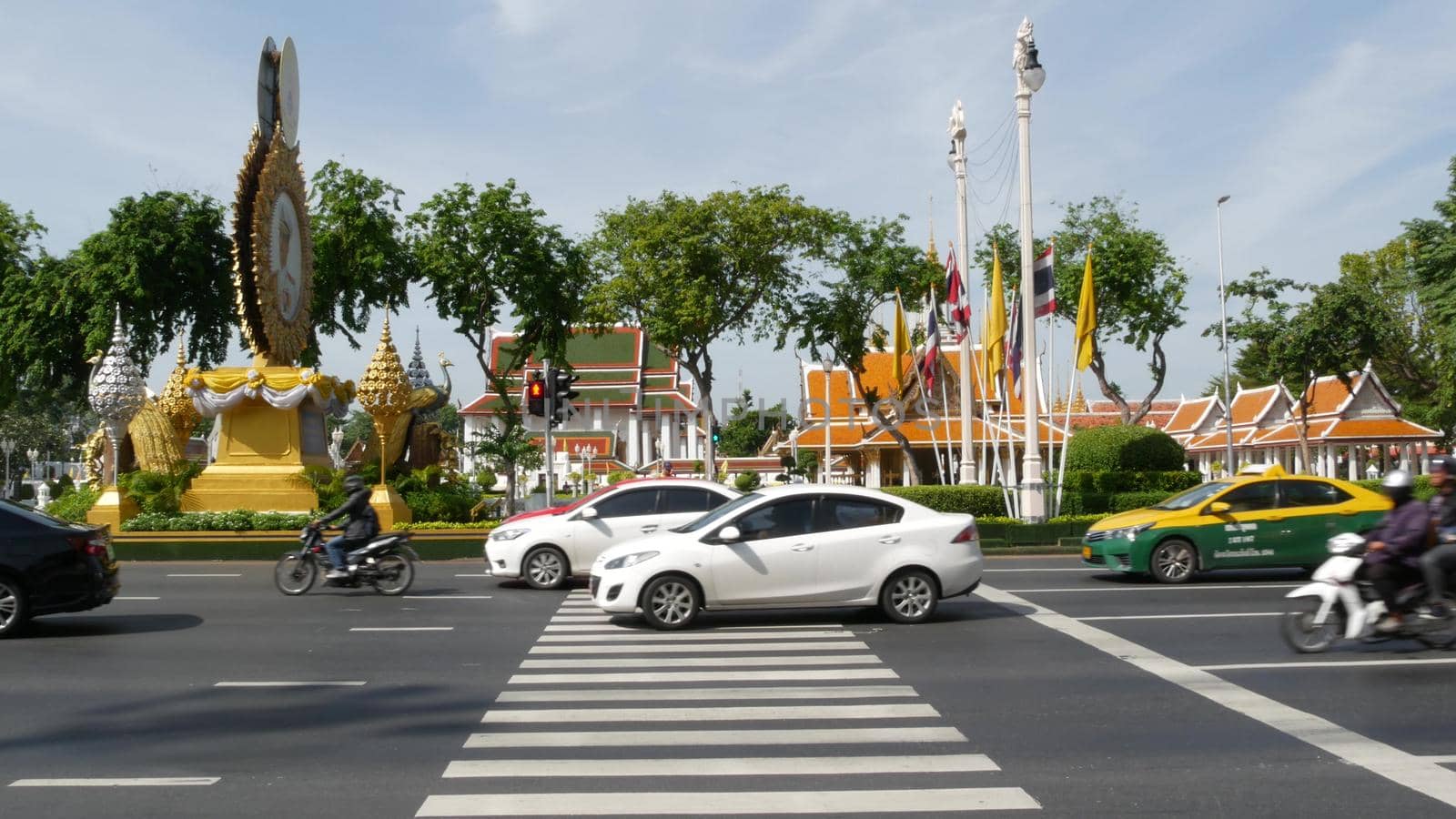 BANGKOK, THAILAND - 11 JULY, 2019: Rush hour traffic near Wat Saket in capital. Famous asian landmark and travel destination. Ancient religious monastery and public transport on the road in downtown