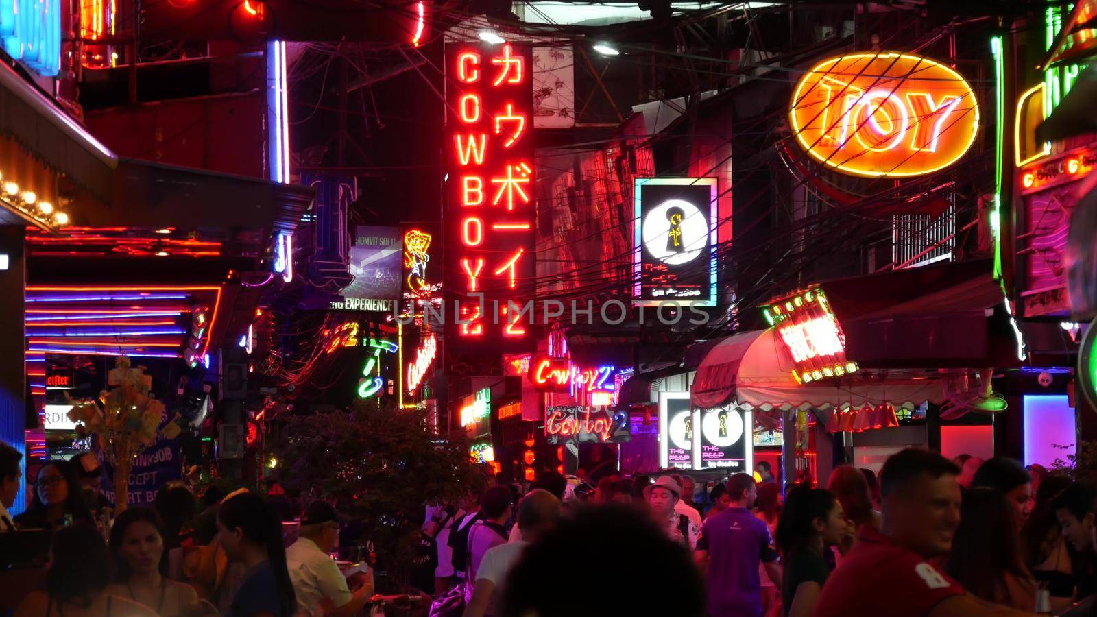 BANGKOK, THAILAND,13 JULY 2019: Vivid neon signs glowing on Soi Cowboy street. Nightlife in erotic Red light district. Illuminated bar and adult go-go show club. Night life tourist entertainment.