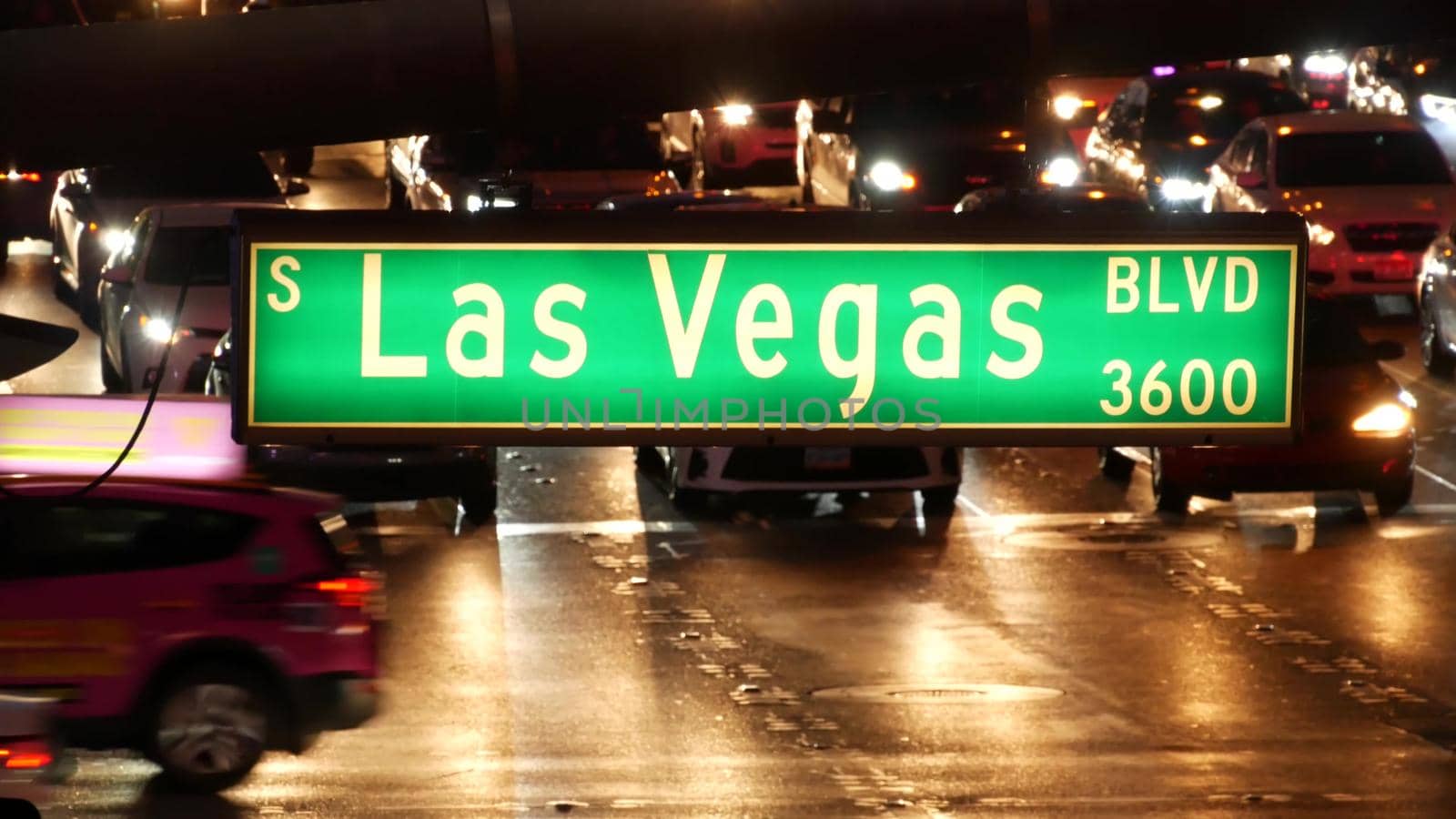 LAS VEGAS, NEVADA USA - 13 DEC 2019: Traffic sign glowing on The Strip in fabulous sin city. Iconic signboard on the road to Fremont street. Illuminated symbol of casino, money playing and betting by DogoraSun