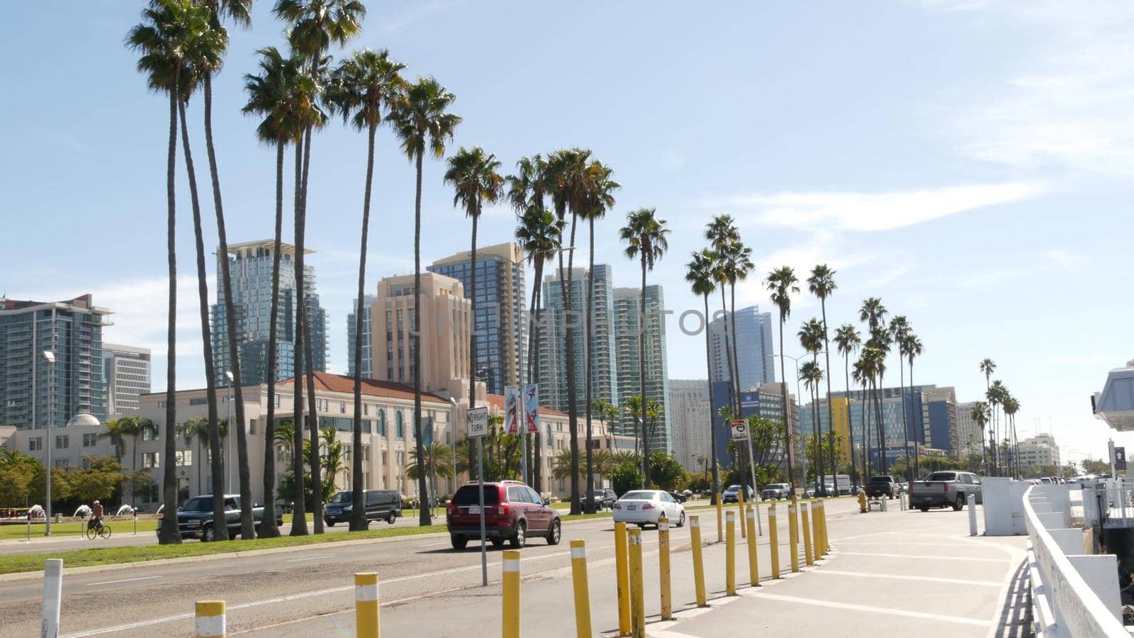 SAN DIEGO, CALIFORNIA USA - 30 JAN 2020: County civic center in downtown. Urban skyline of Gaslamp Quarter. Cityscape of metropolis, pacific harbour waterfront with palm trees. Cars drive on road by DogoraSun