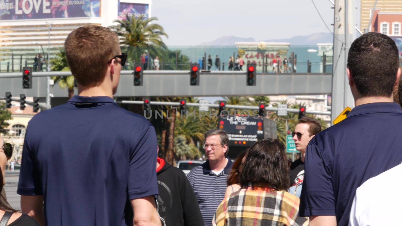 LAS VEGAS, NEVADA USA - 7 MAR 2020: People on pedestrian walkway. Multicultural men and women walking on city promenade. Crowd of citizens on sidewalk. Diversity of multiracial faces in metropolis.