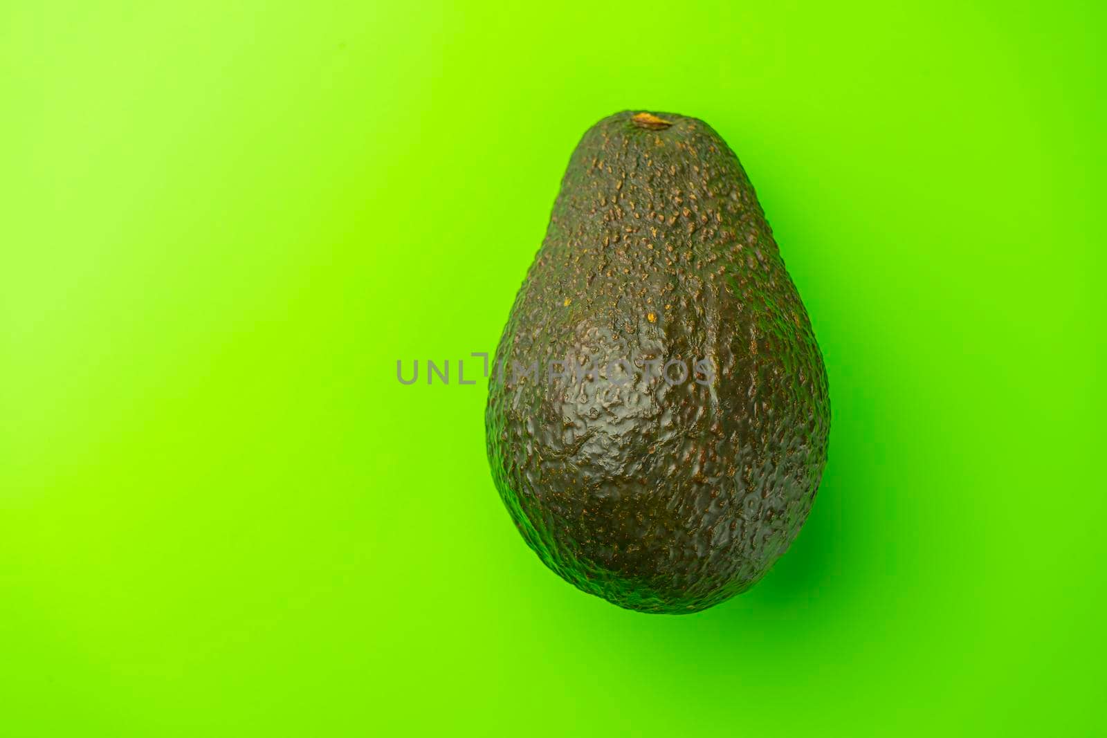 avocado on a green background close-up. isolate by roman112007