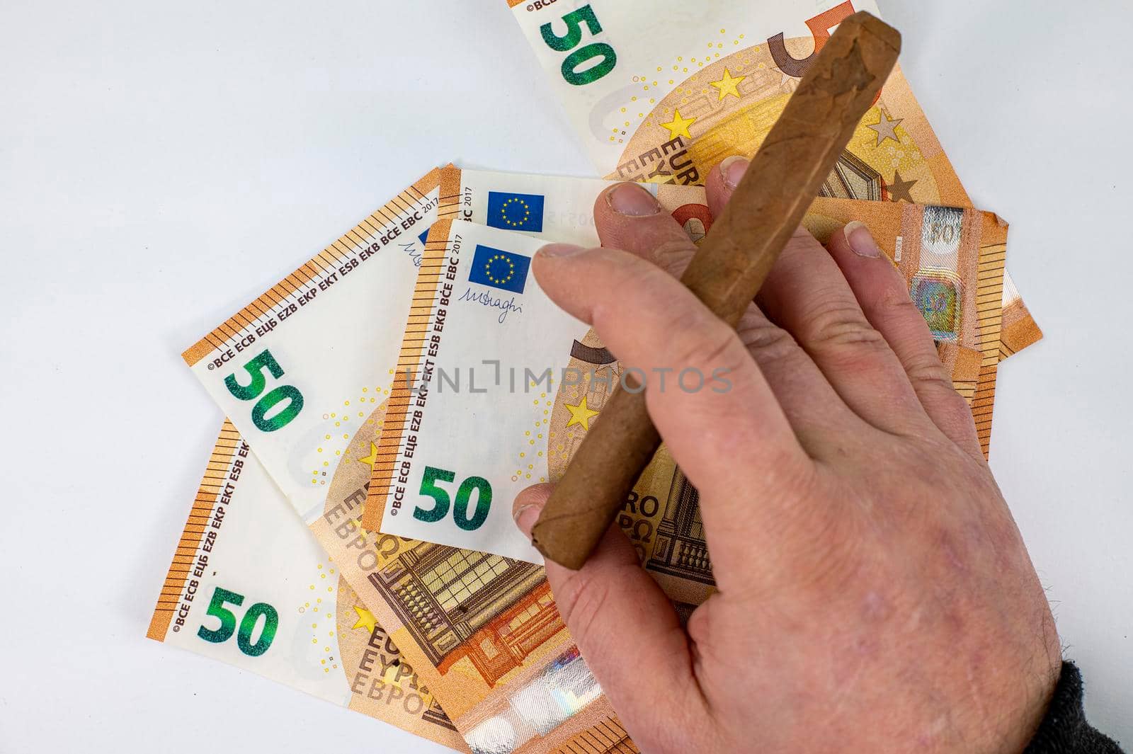 50 euro bills with man hand holding cigar on white background
