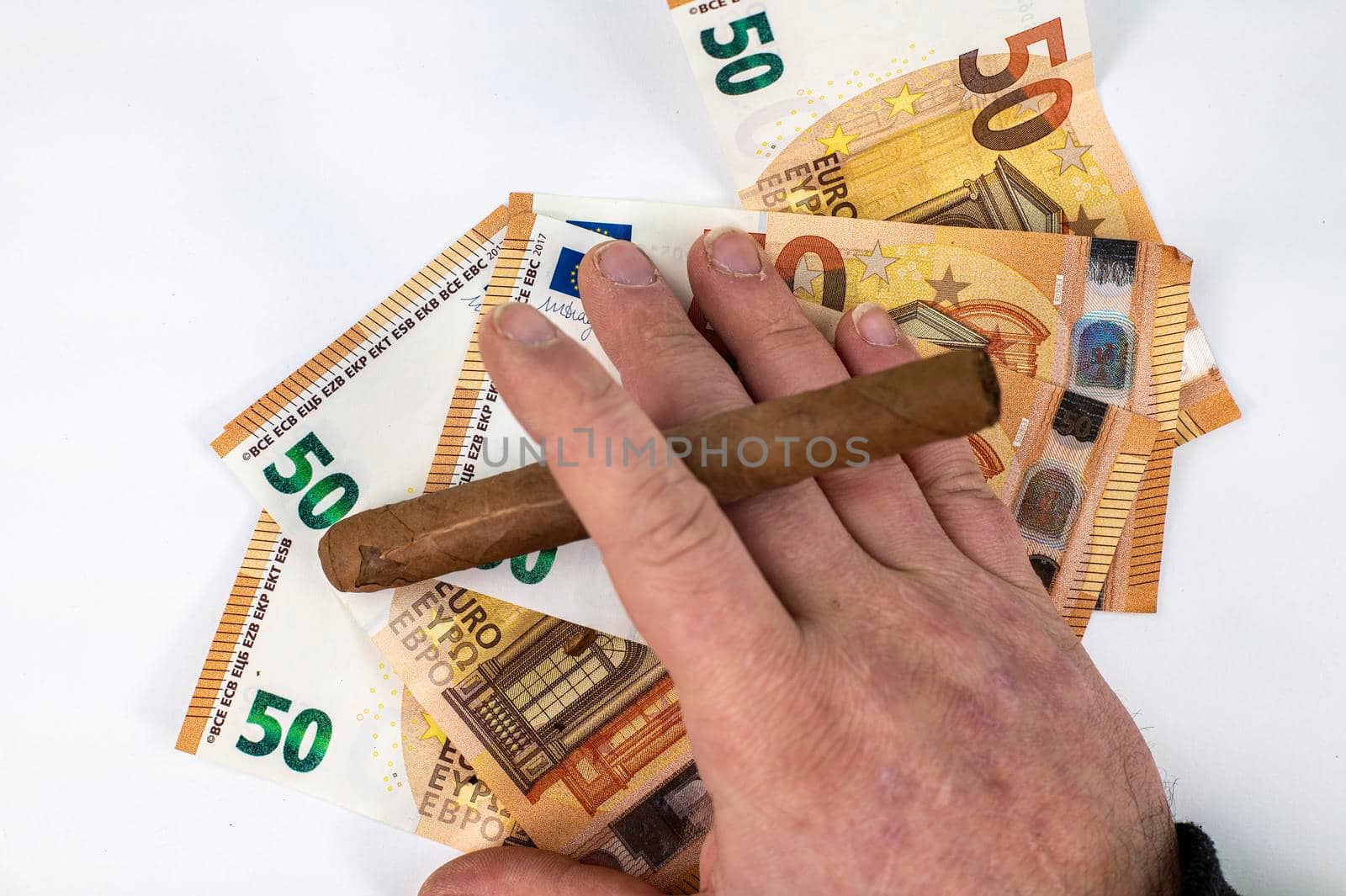 50 euro bills with man hand holding cigar on white background