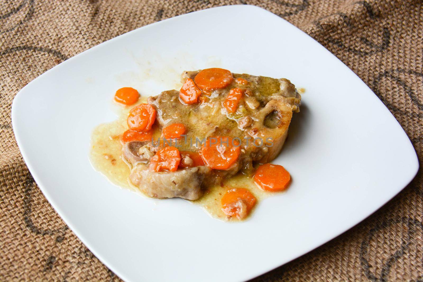 homemade marrowbone with the grandmother's recipe of carrots, celery, tomatoes and slow cooking