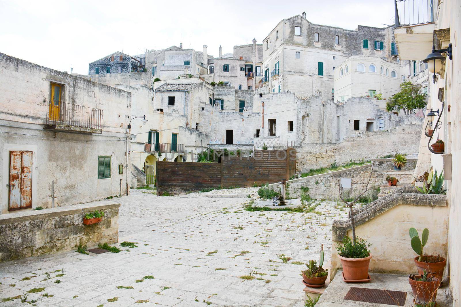 Matera, an ancient courtyard carved into the rock and the houses also dug into the mountain