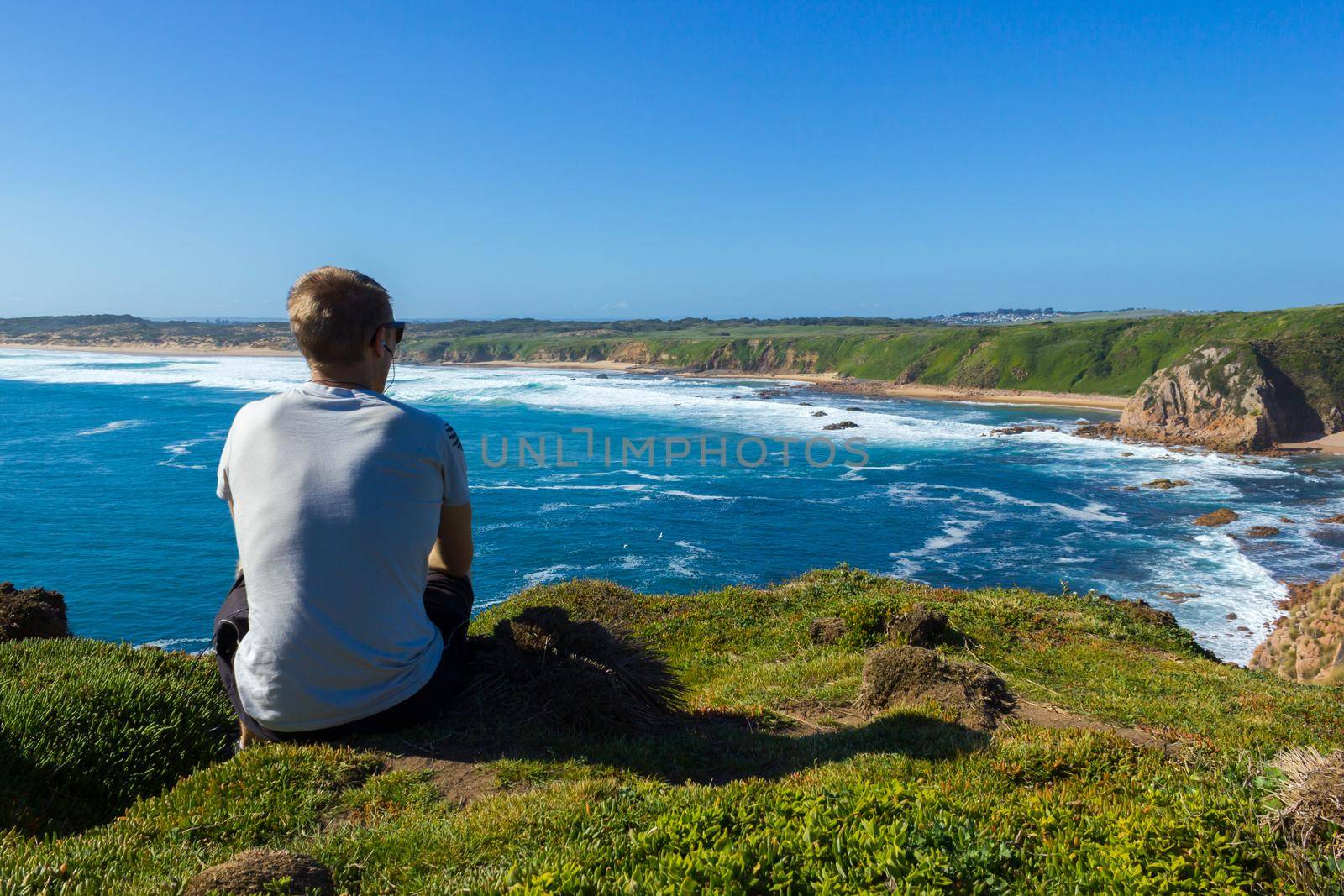 young man enyoing view over Woolamai beach, philip island, victoria, australia by bettercallcurry