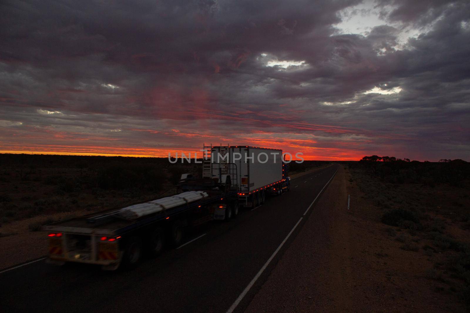NORTHERN TERRITORY, AUSTRALIA - APRIL 12, 2010: Roadtrains in desert in Northern Territory on April 12, 2010, Australia. A roadtrain use in remote areas of Australia to move freight efficiently.
