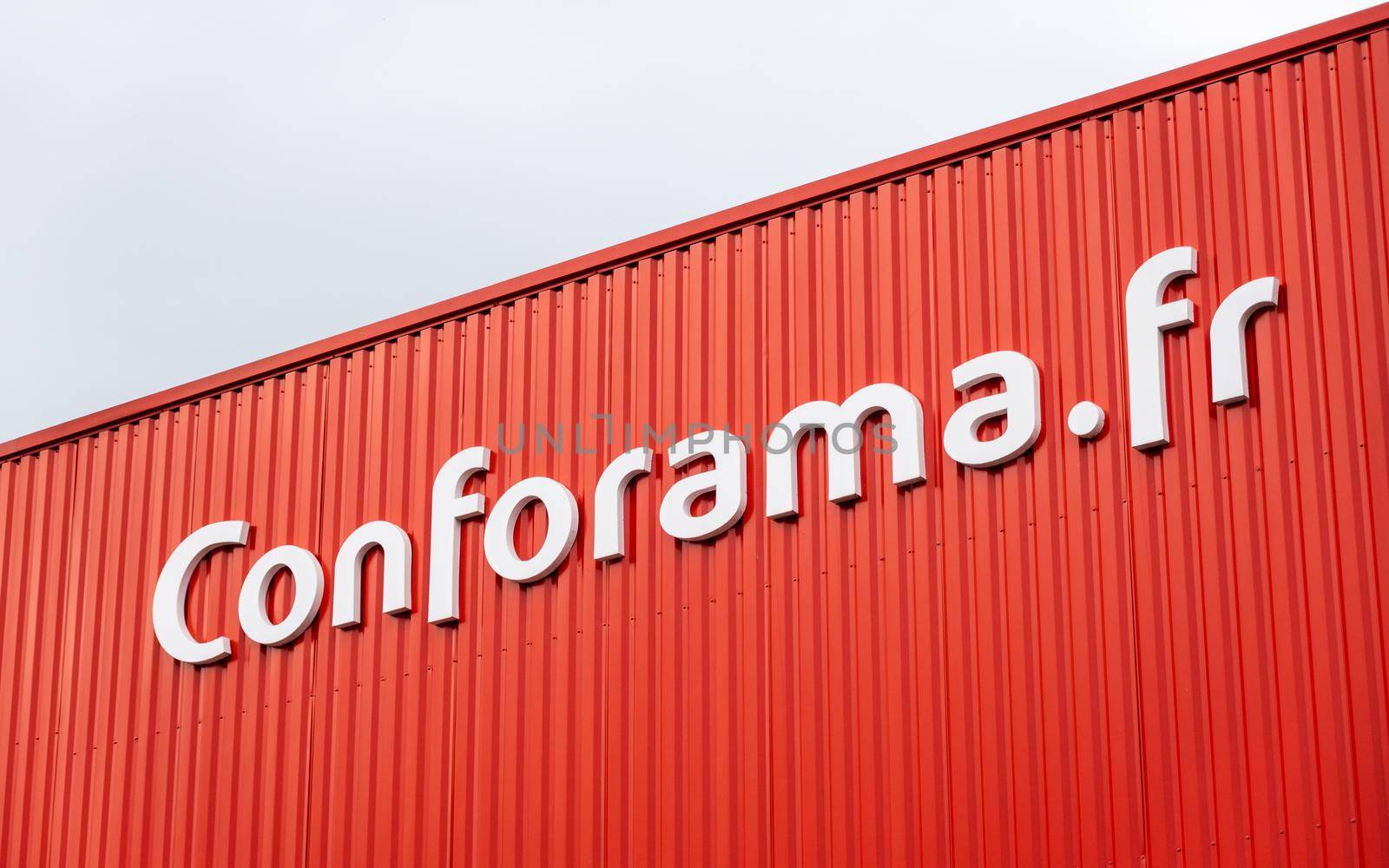 Conforama sign on red store facade, in Anglet, France by dutourdumonde