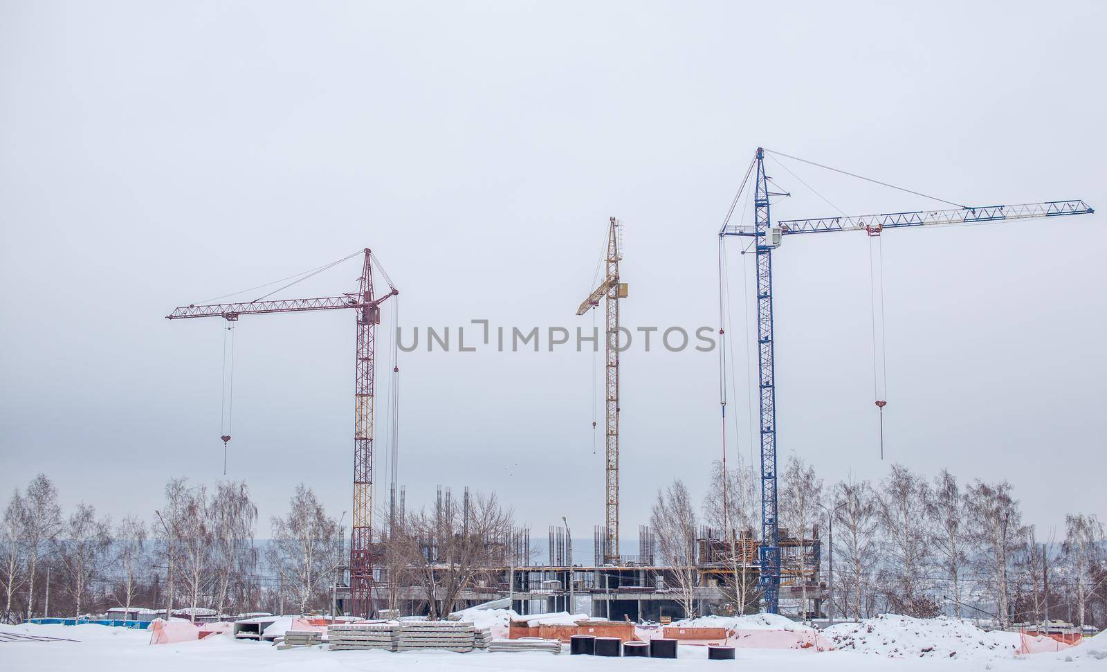 High-rise crane for construction on the sky background. Construction site with high-rise cranes. Sale of a tower crane during the economic crisis.