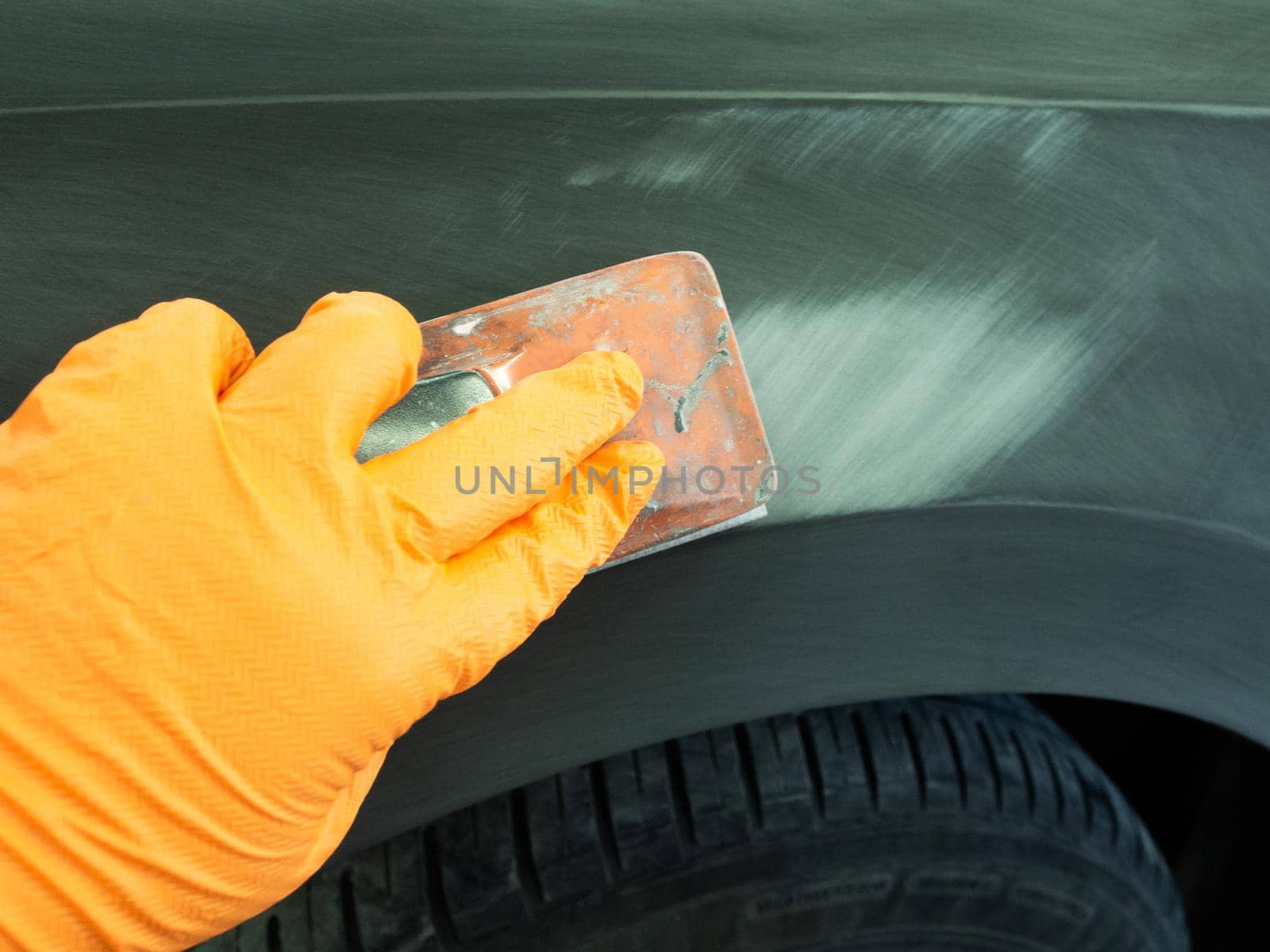 the process of treating the soil with an abrasive material manually. manual repair of car paintwork.