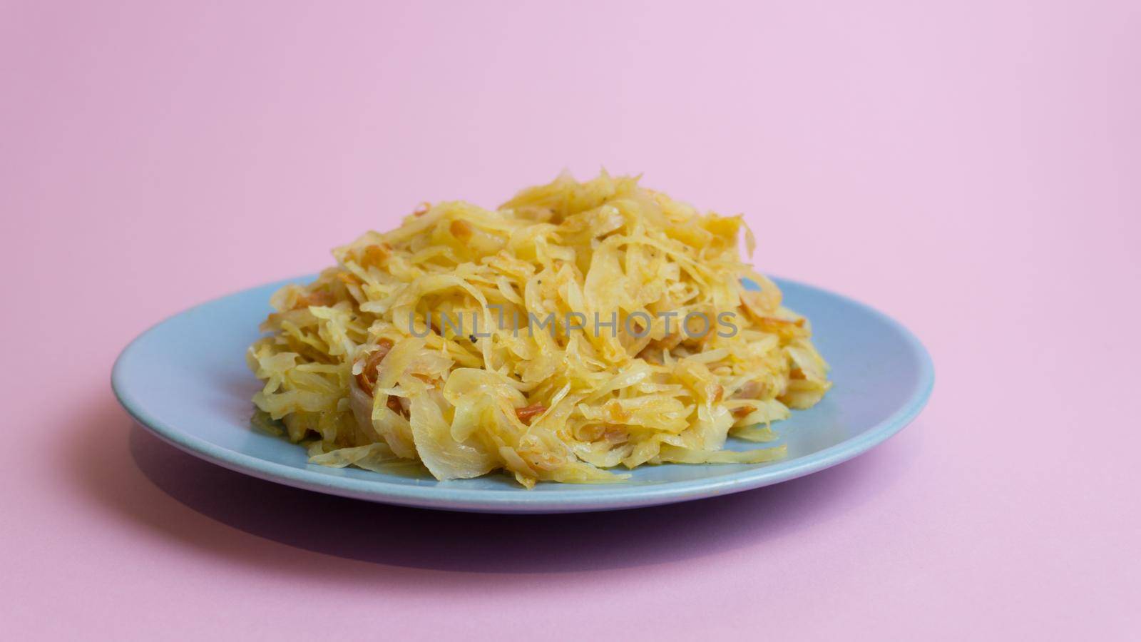 Stewed white cabbage on a plate. A dish of Russian, Polish cuisine. Garnish in the USSR.
