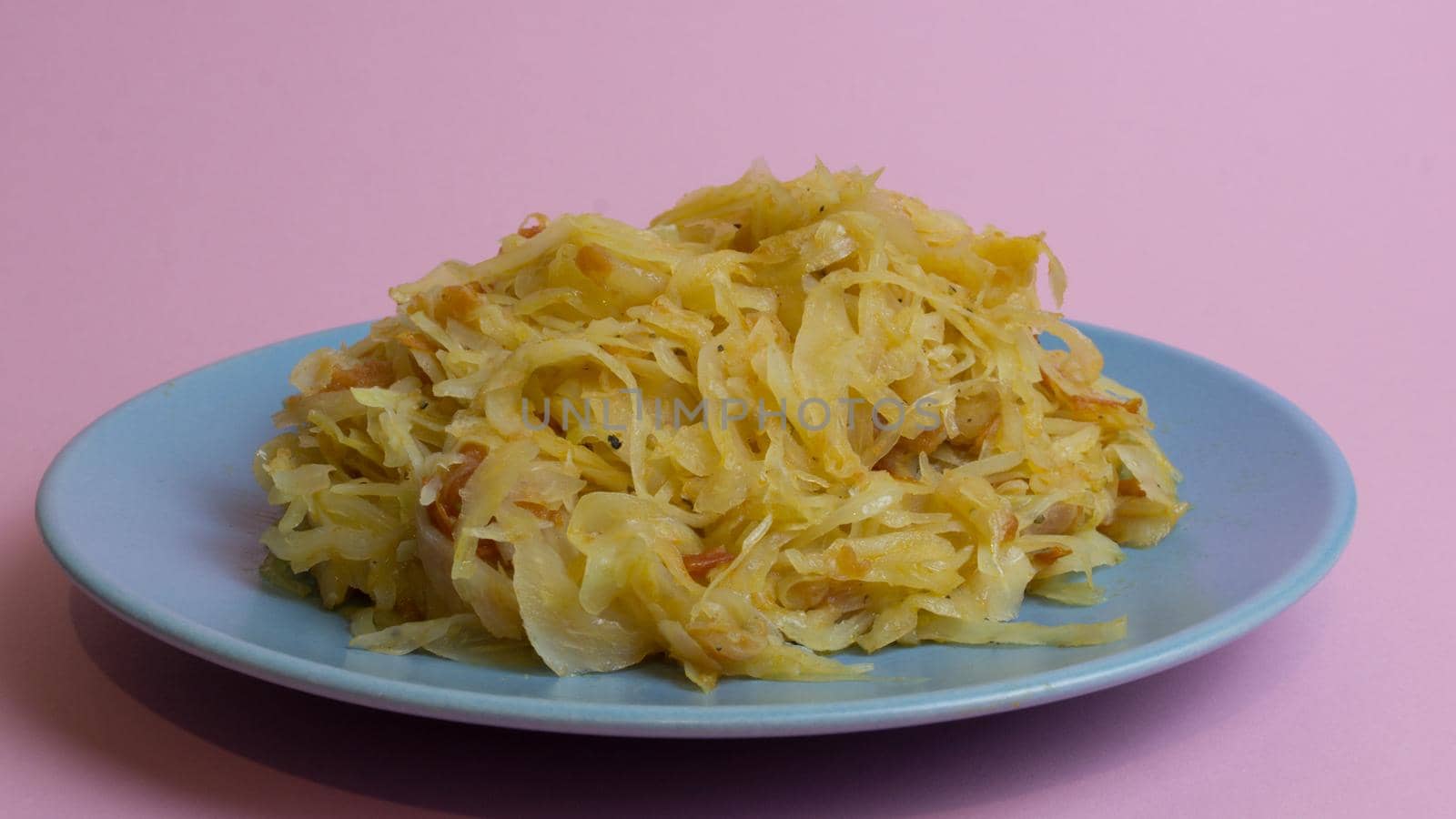 Stewed white cabbage on a plate. A dish of Russian, Polish cuisine. Garnish in the USSR.