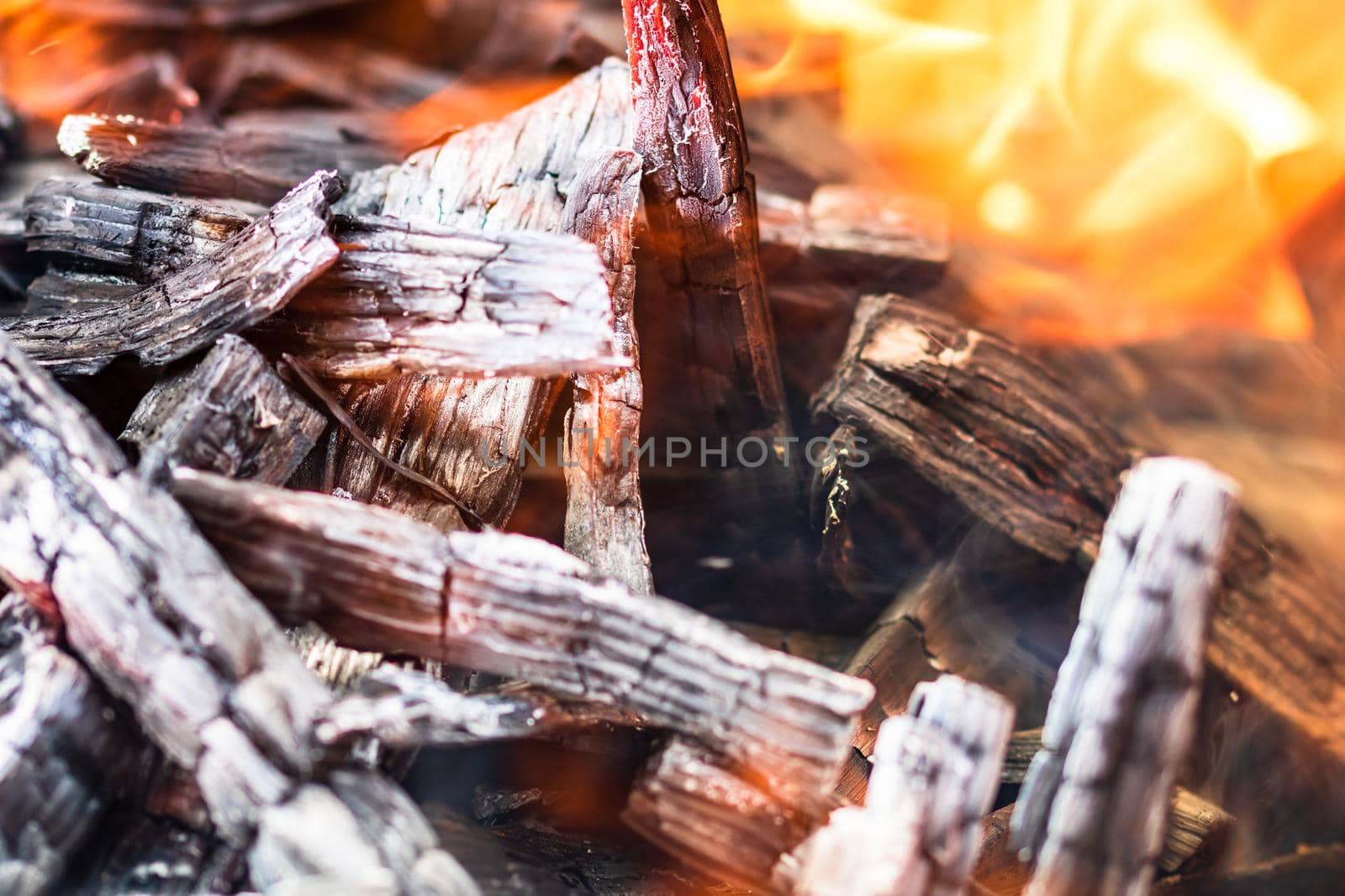 Burning wood chips forming coal. Barbecue preparation, fire before cooking. Hot coal made of greatly heated wood.