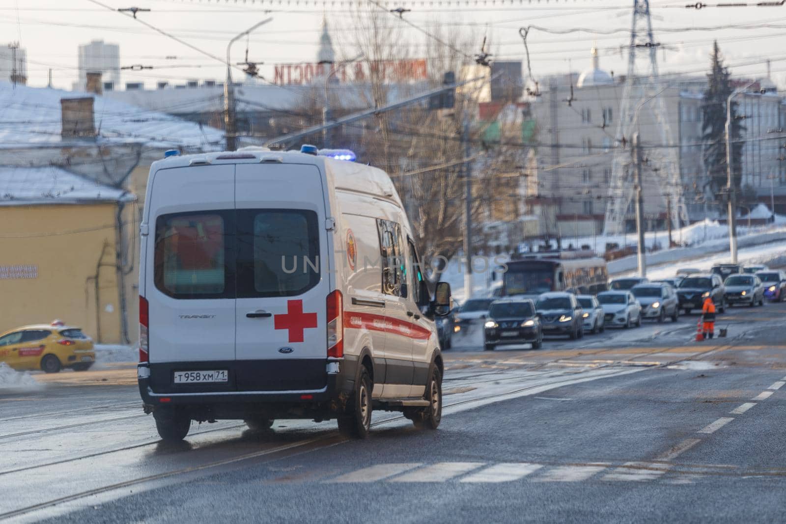 White ambulance minibus on winter wet street lane. by z1b