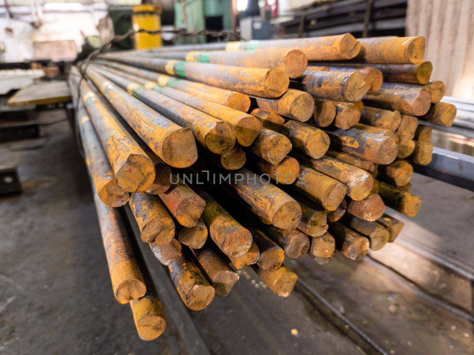 rusted long round steel bars pack - close-up with selective focus and background blur