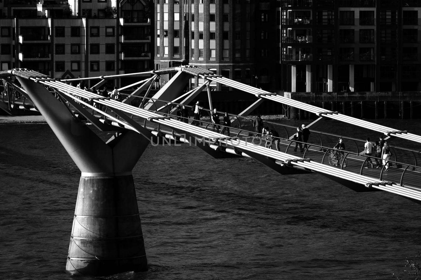 LONDON, UK - CIRCA JUNE 2011: Black and white shot of the Millennium Bridge. The Millennium Bridge is a steel suspension bridge over the Thames River for pedestrians.