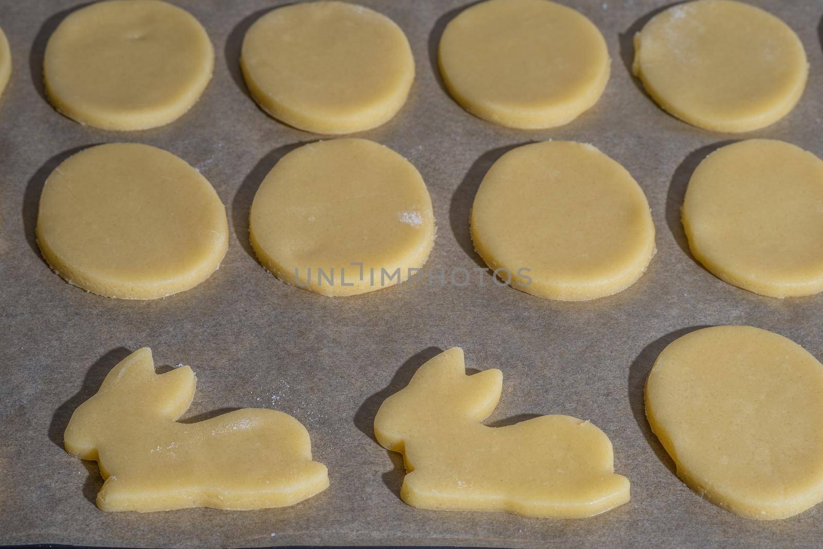 Various easter cookies on baking tray as background.