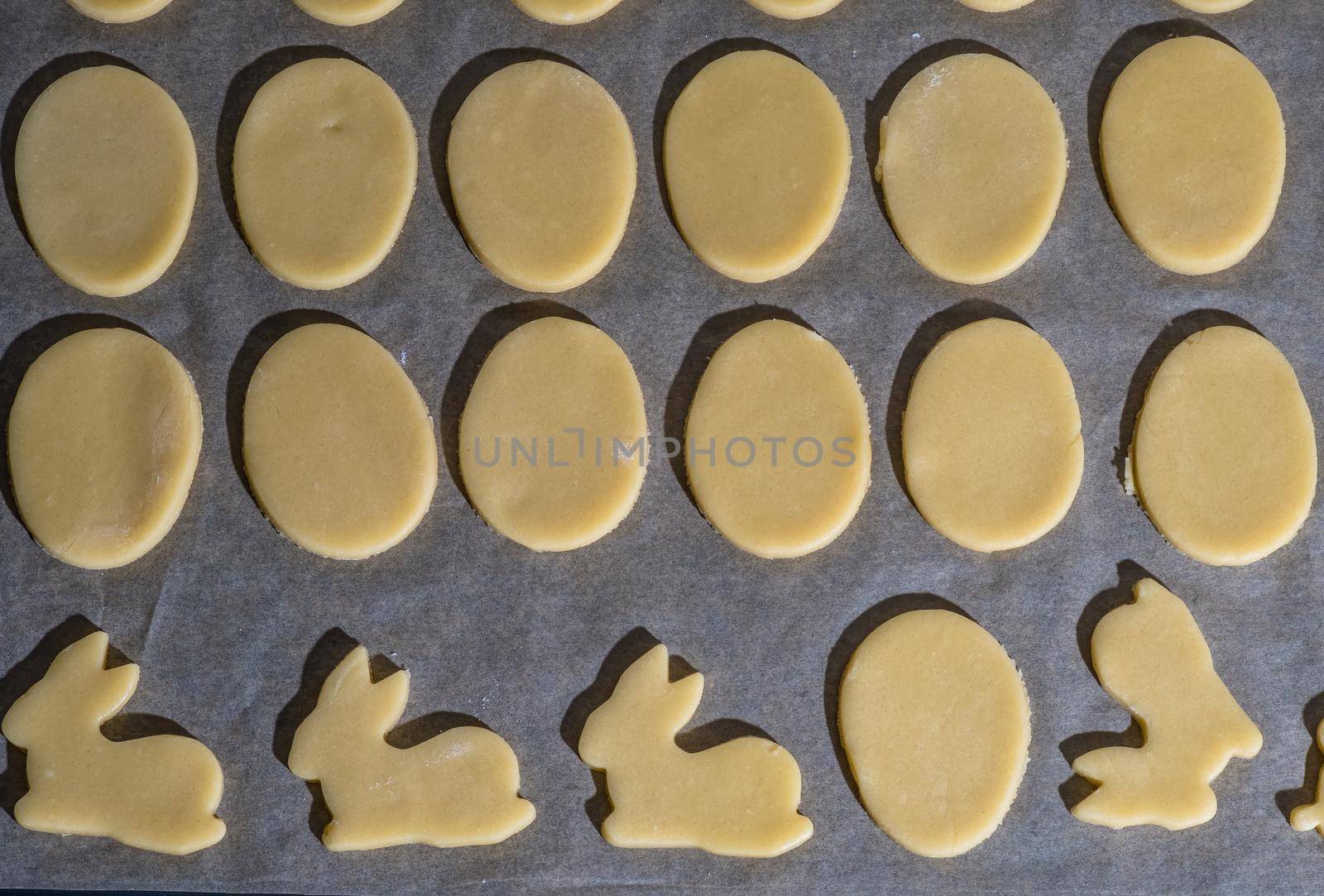 Various easter cookies on baking tray as background.