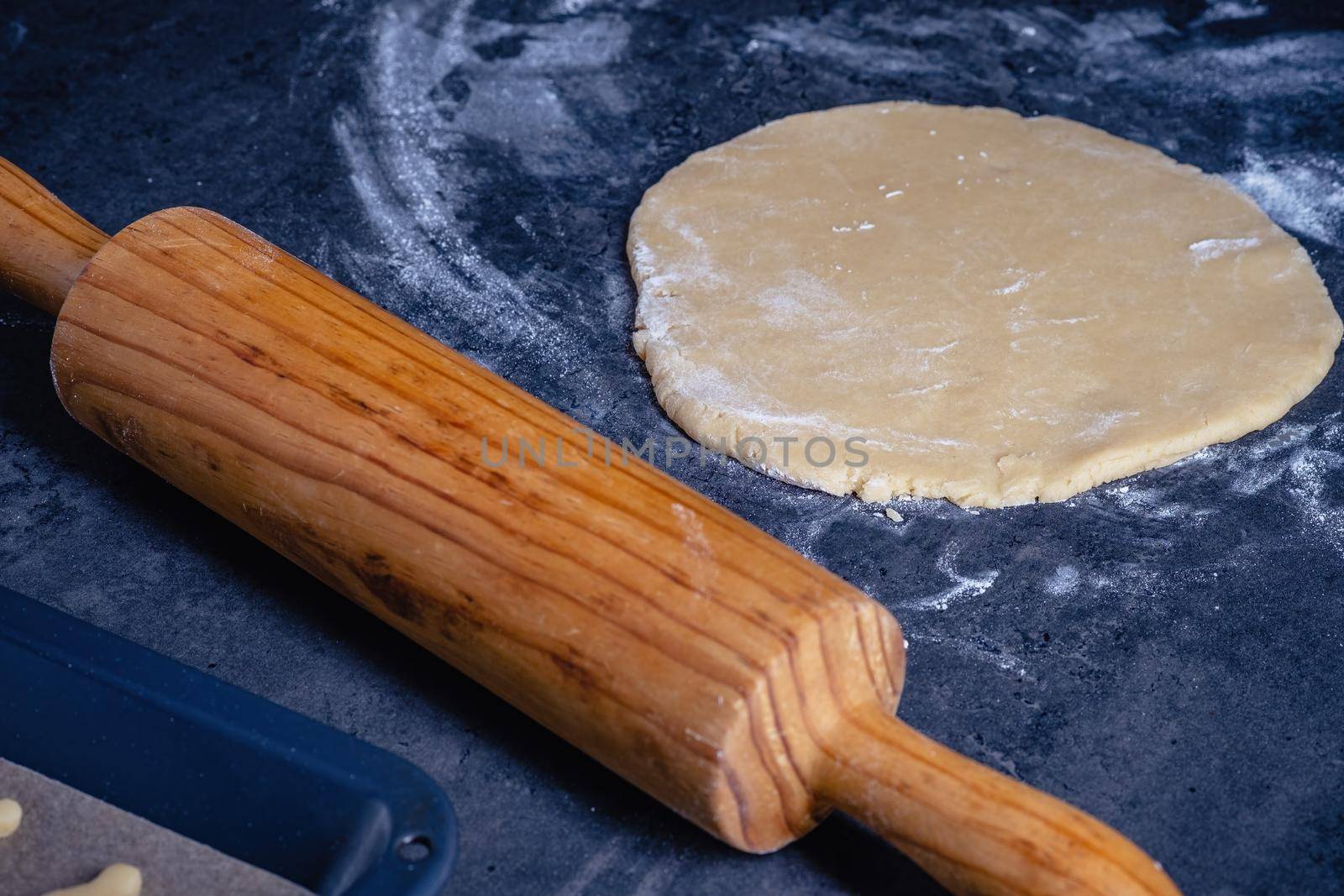 Rolling pin and kitchenware for making easter cookies on dark background by Fischeron