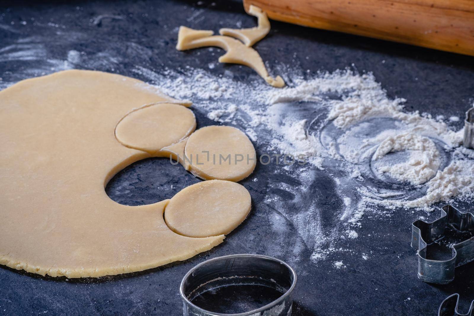 Rolling pin and kitchenware for making easter cookies on dark background by Fischeron